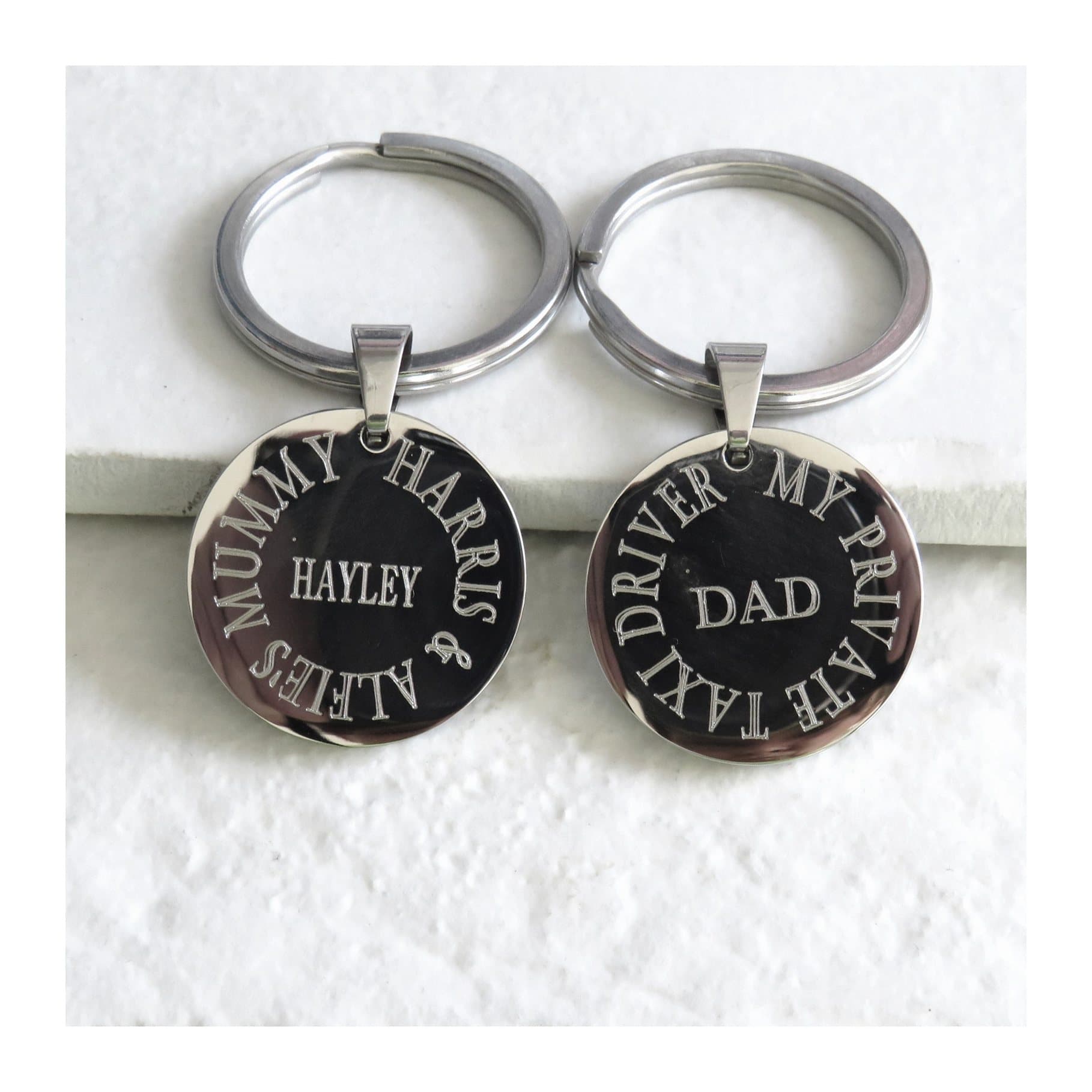 Round stainless steel keyring with a personalised engraved centre and message