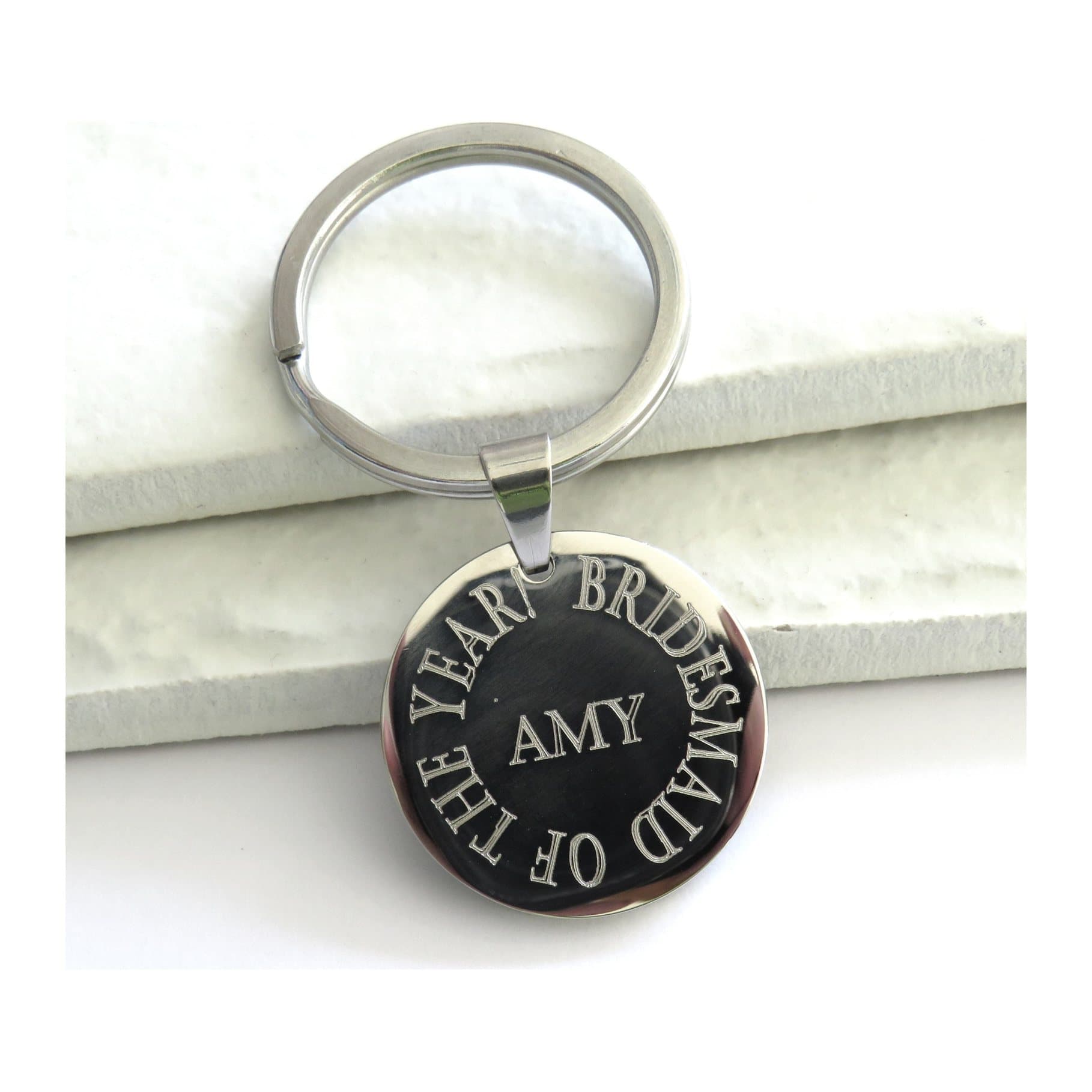 Round stainless steel keyring with an engraved personalised message