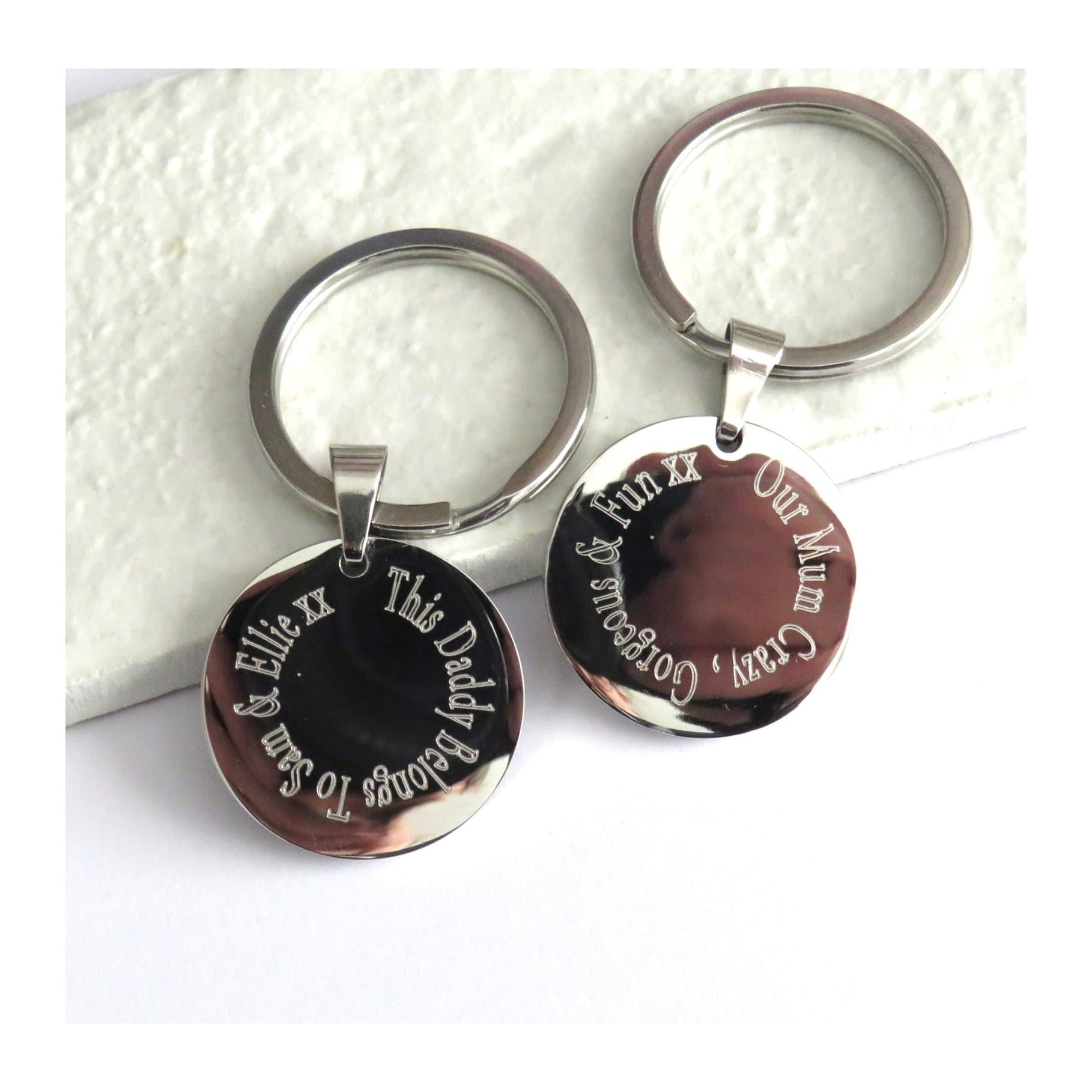 Round polished stainless steel keyring with words engraved on the edge