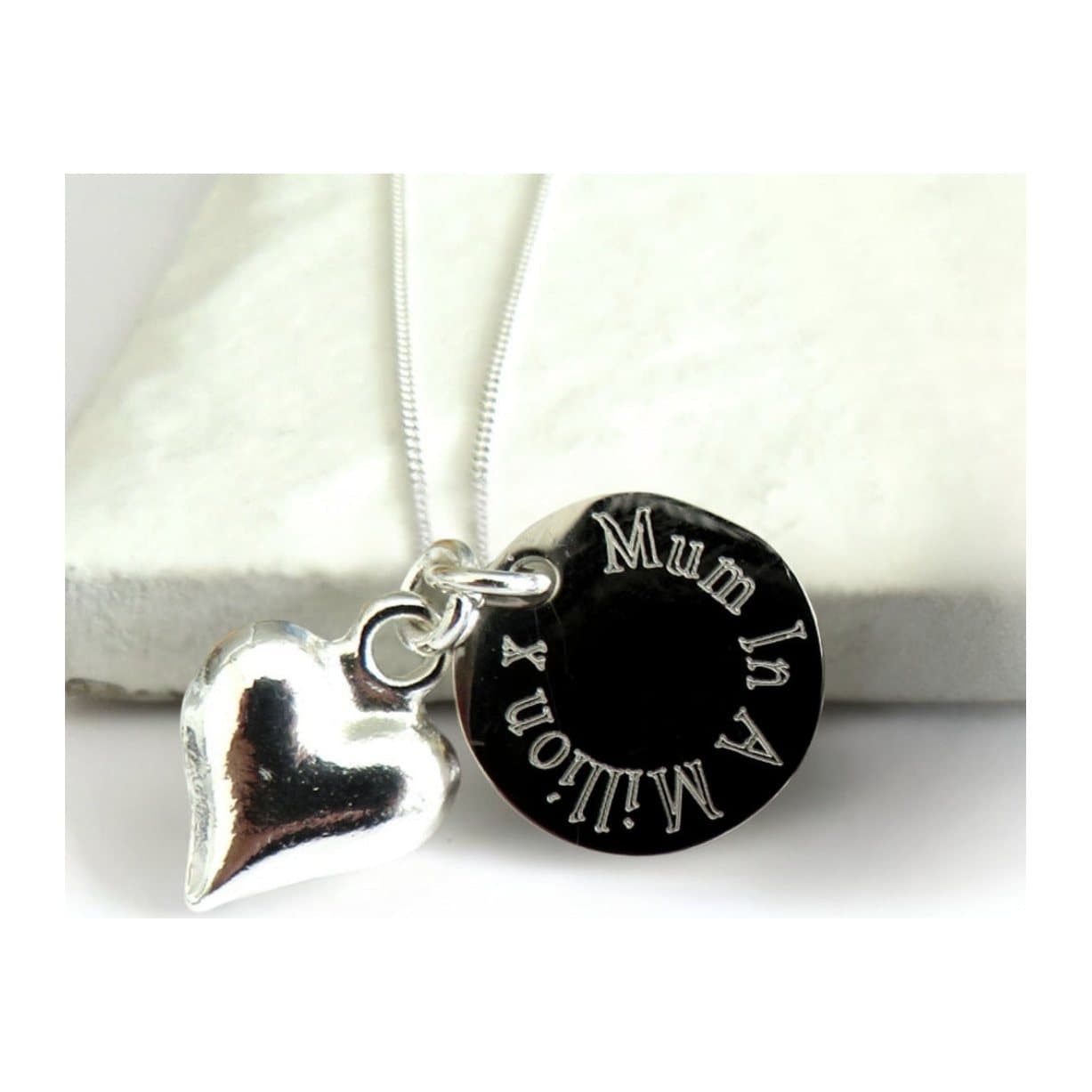 Personalised silver heart charm necklace with a round engraved disc on a chain