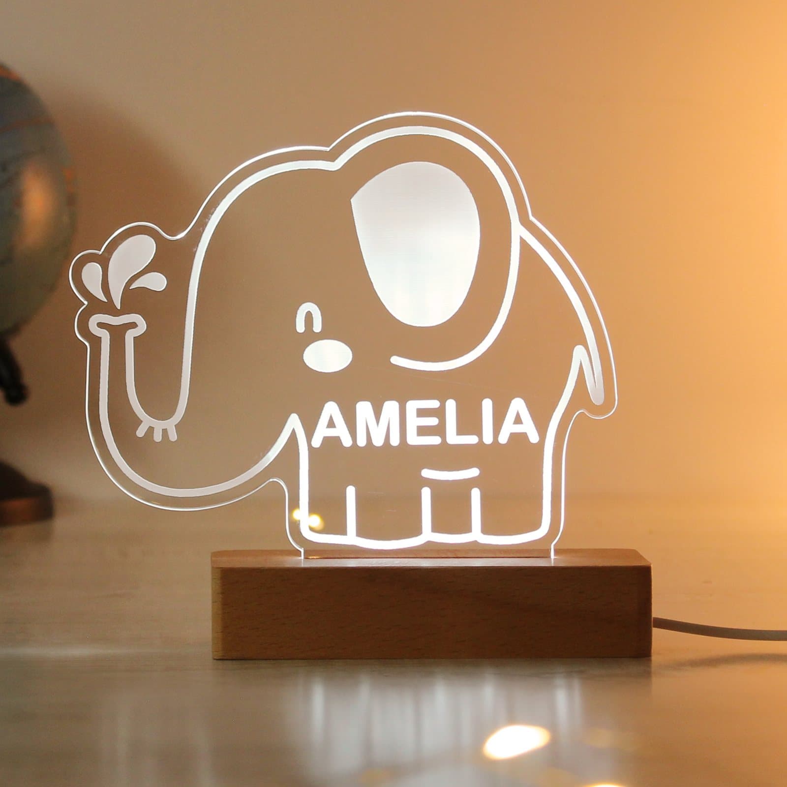 Personalised elephant LED light with a wooden base and a name
