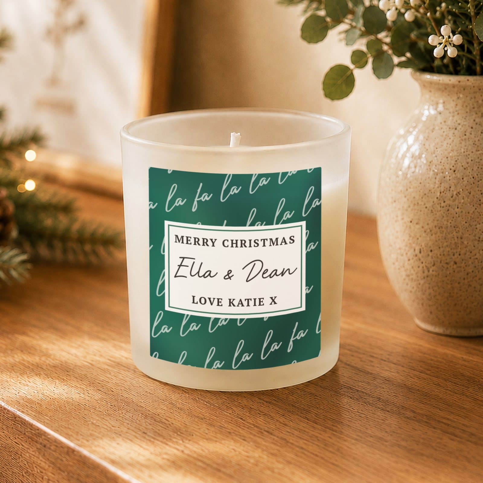 Scented glass candle jar with a green Fa La La label and personalised text