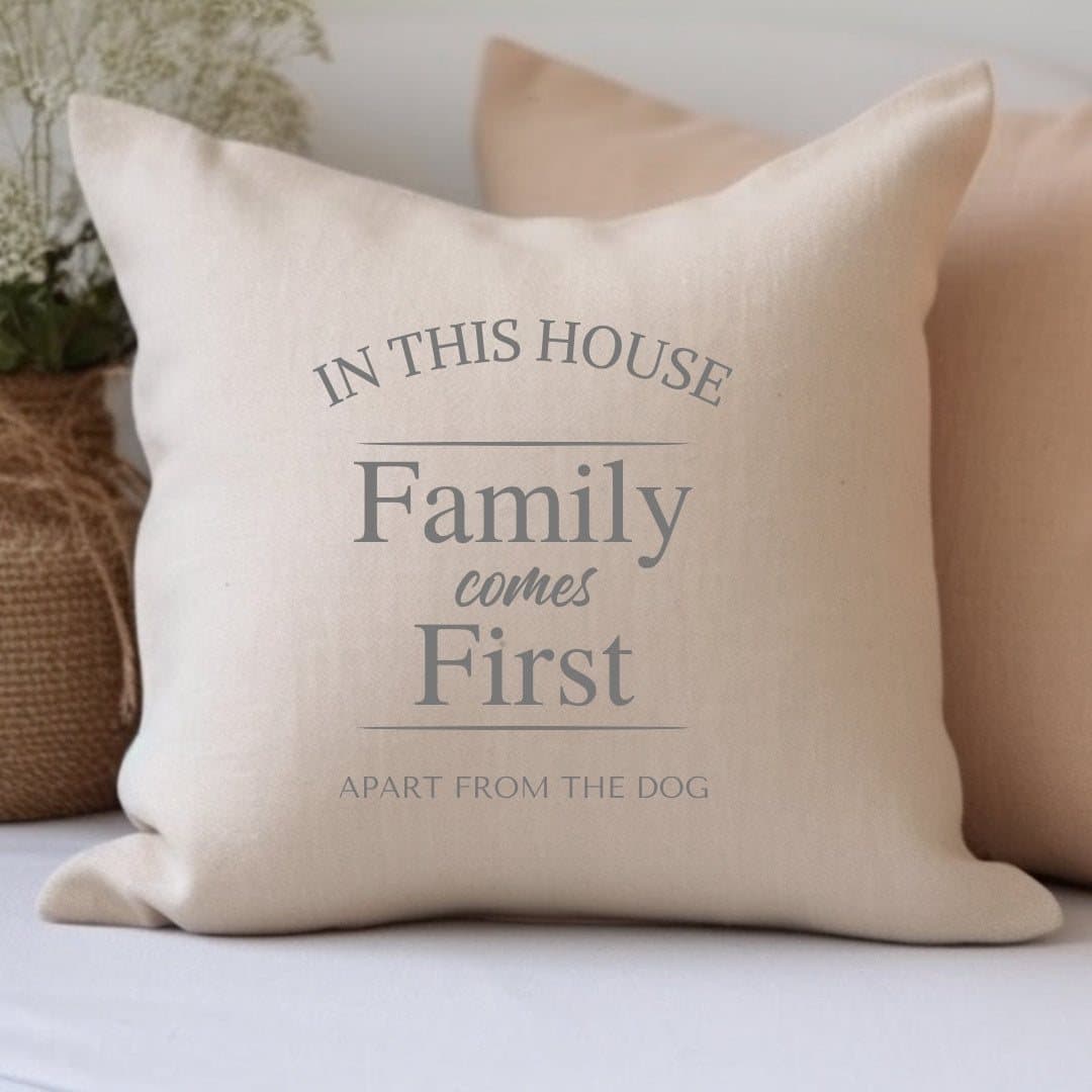 Square cream cushion printed with IN THIS HOUSE Family comes First
