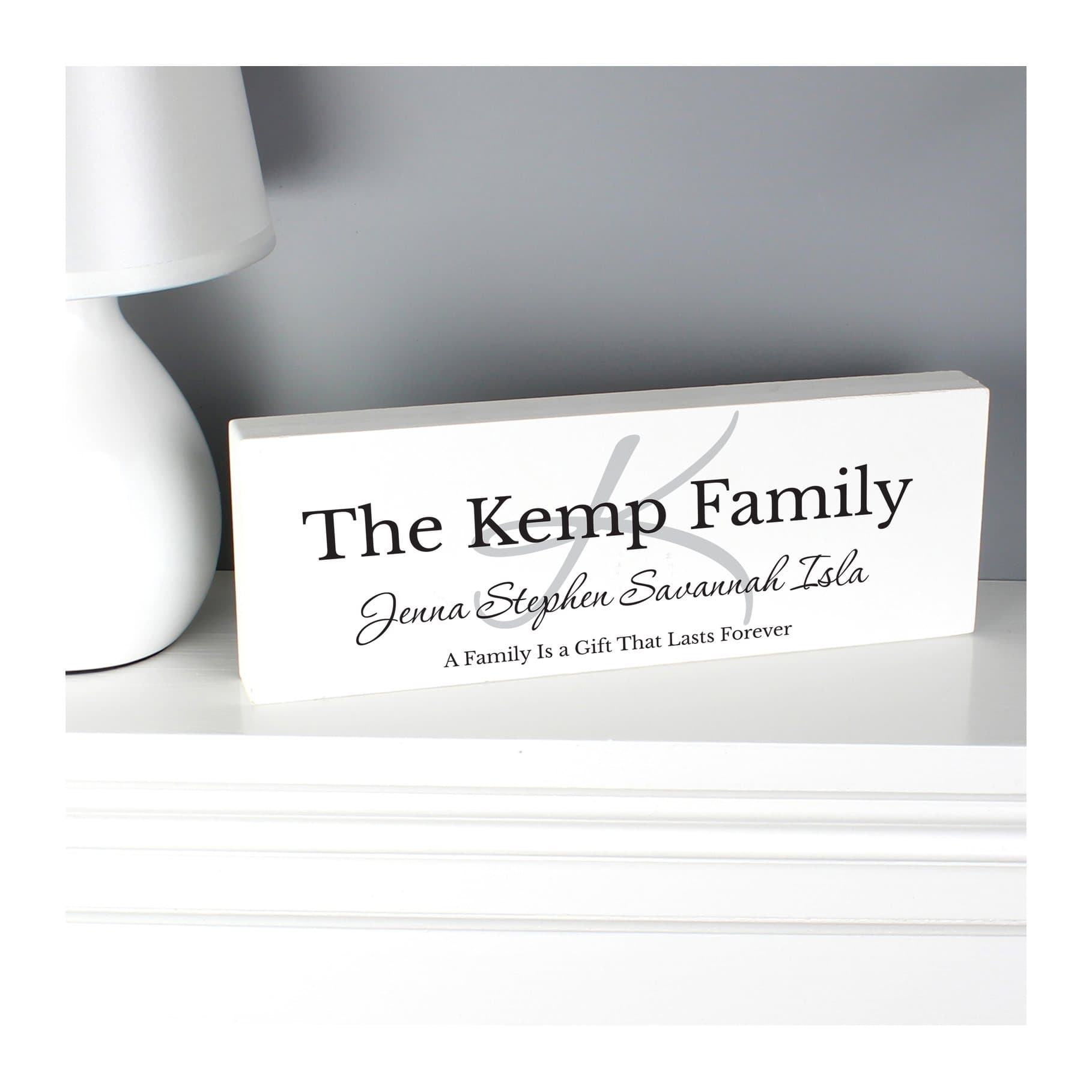 Solid wood block sign with initial, larger text and script message