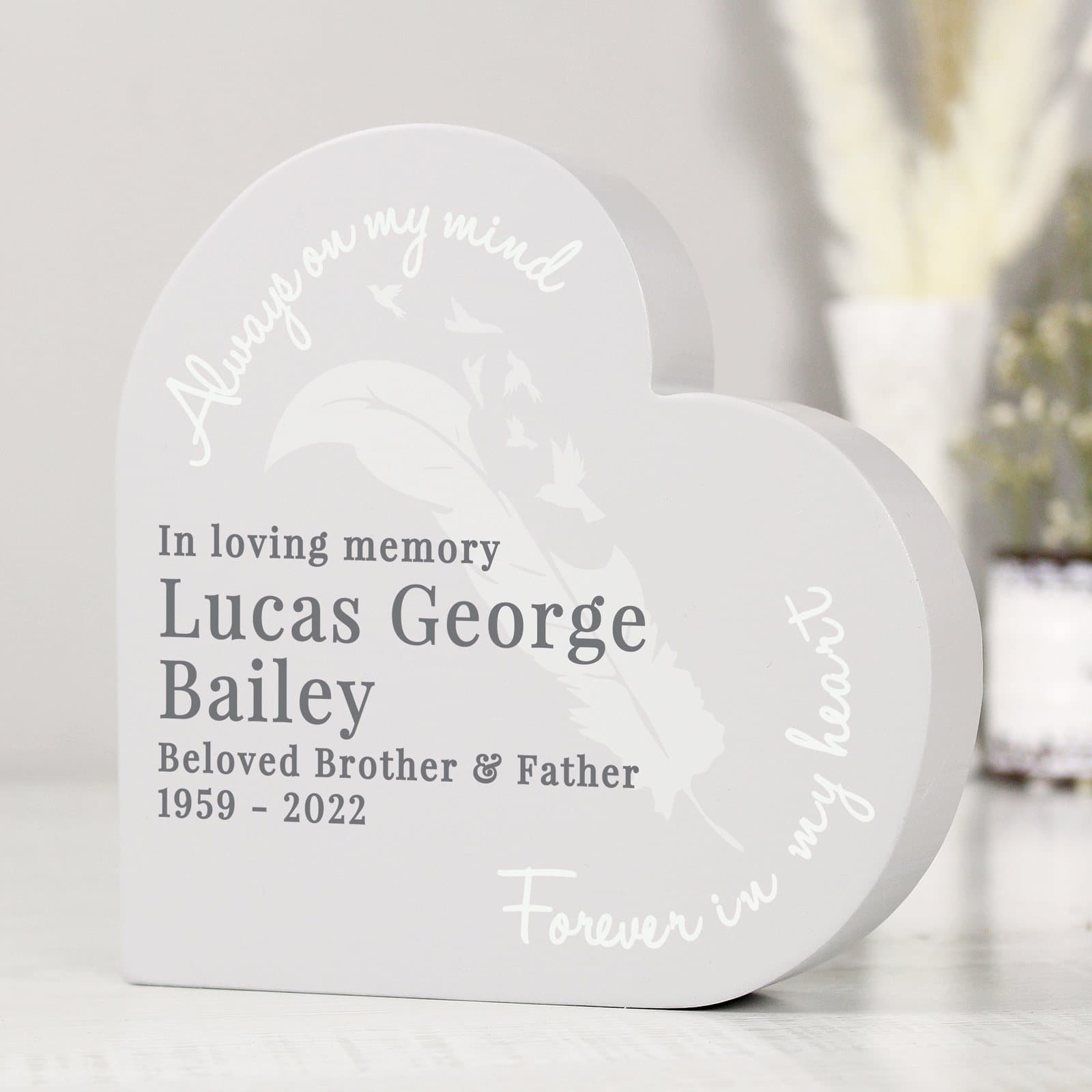 Grey painted wooden free standing heart ornament with feather design and personalised text