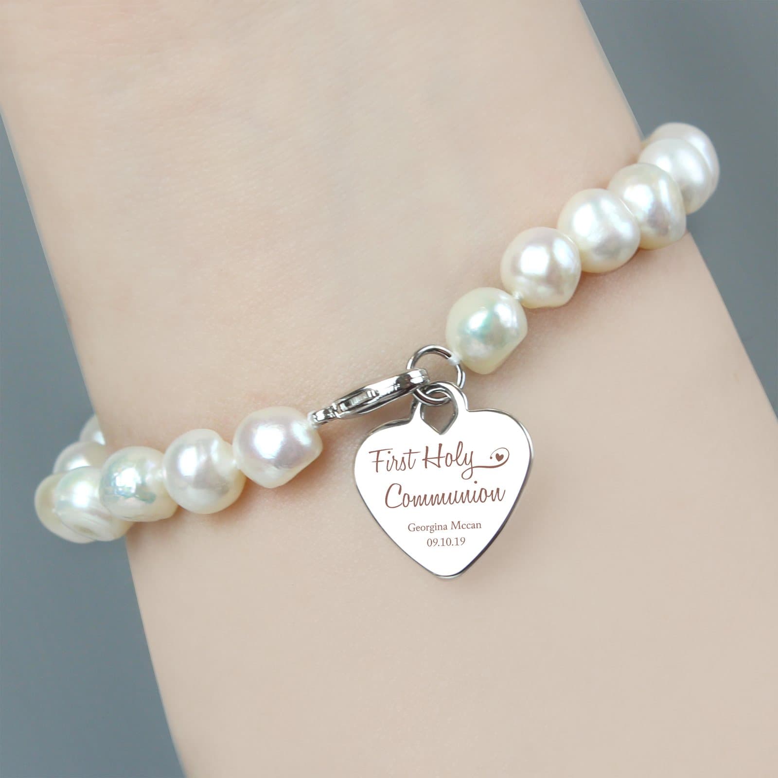 White freshwater pearl bracelet with a rhodium plated heart tag