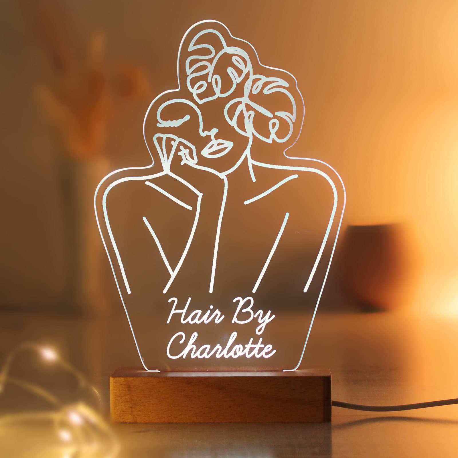 Fleur line art LED sign standing on a wooden base