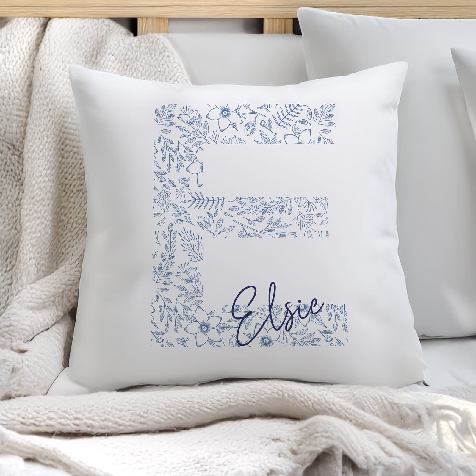 Floral blue cushion with a personalised initial and name