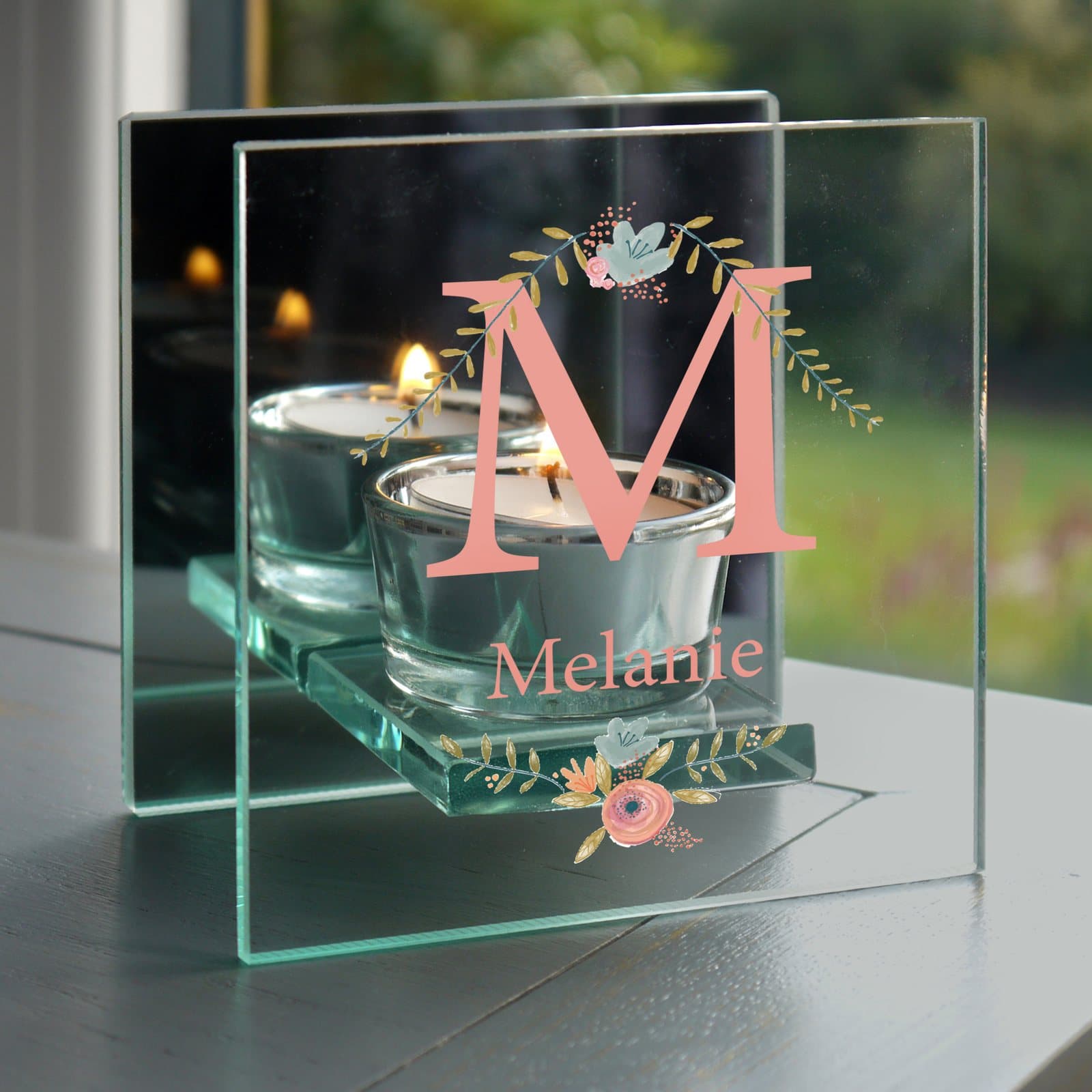 Mirrored glass tea light holder with a floral bouquet design, an initial and a name