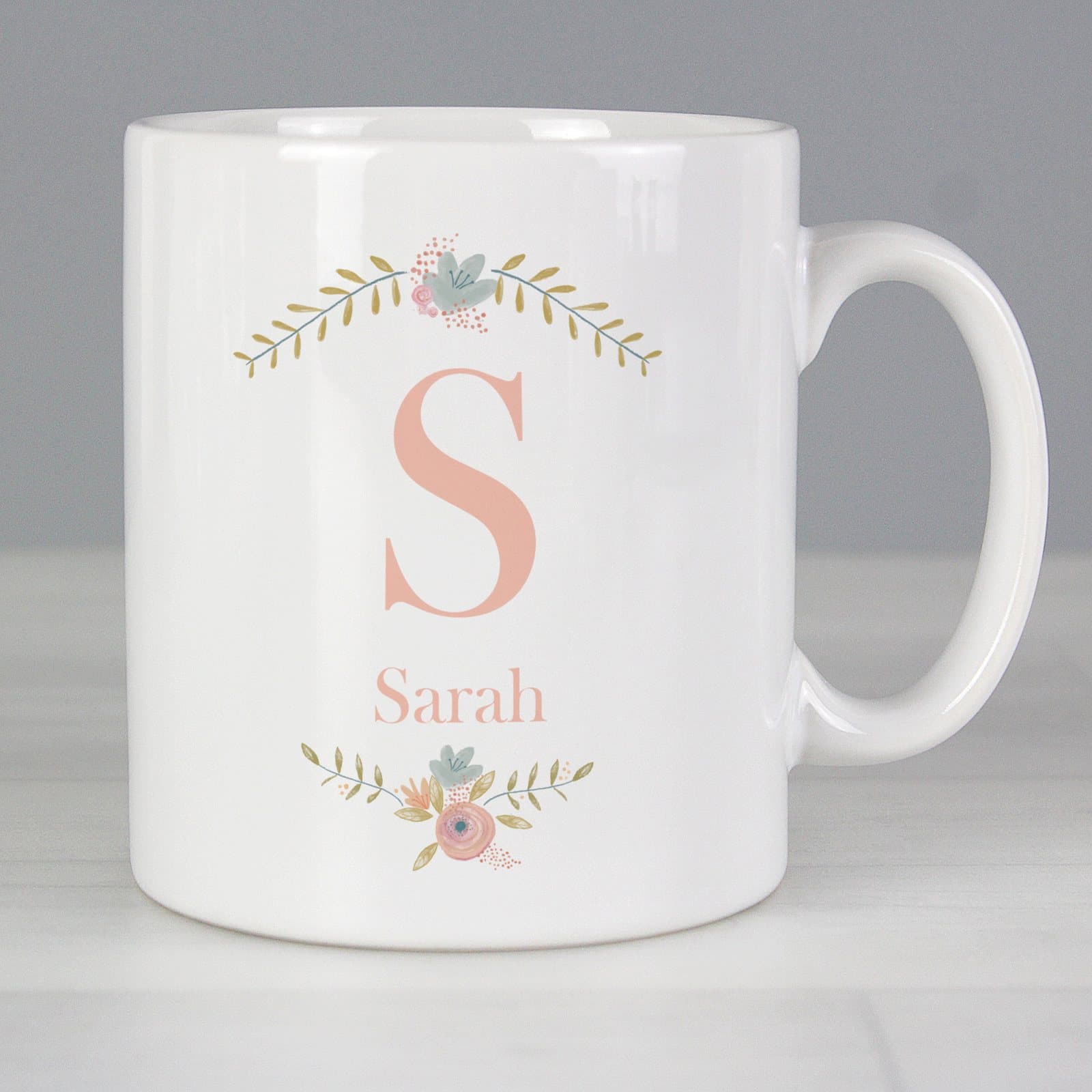 Floral ceramic mug with a bouquet design, an initial and a personalised name