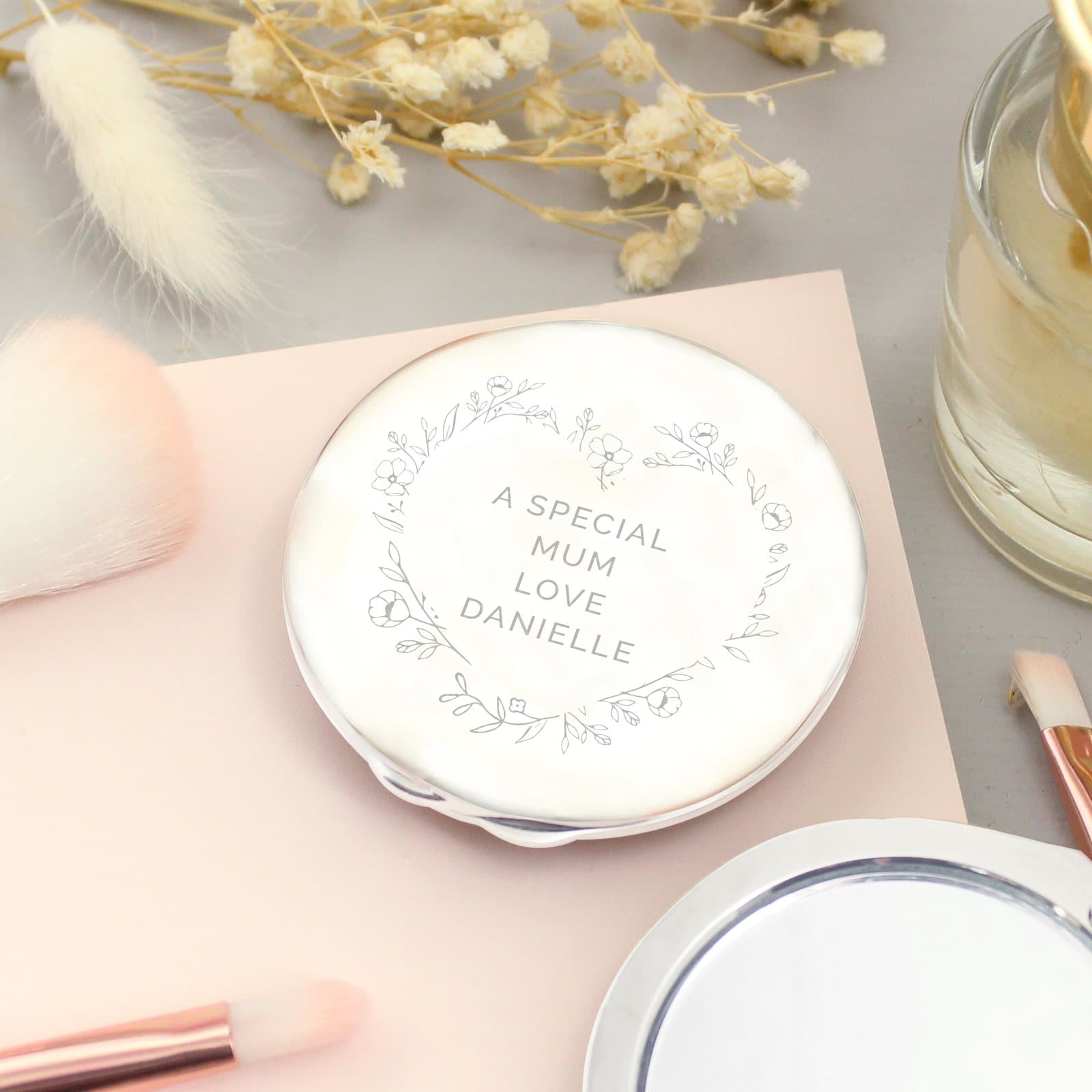 Nickel plated compact mirror with a floral heart motif