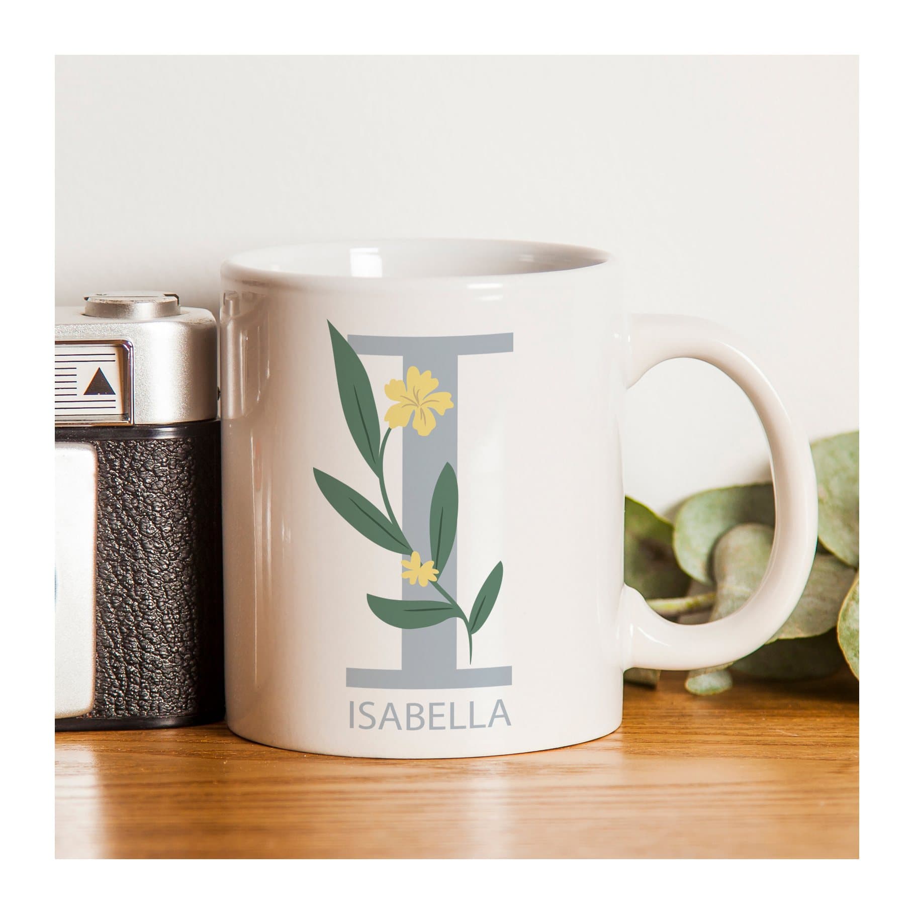 Floral ceramic mug with a personalised initial and name on the front