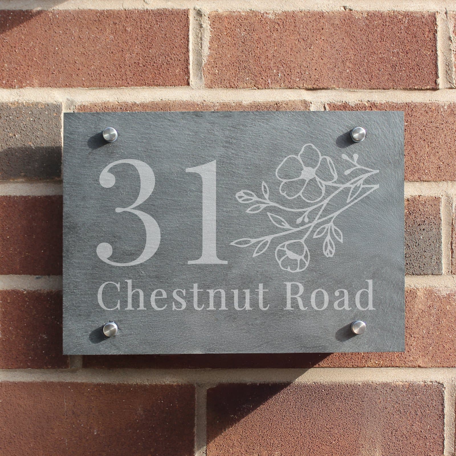 Floral slate house sign with a house number and a line of text