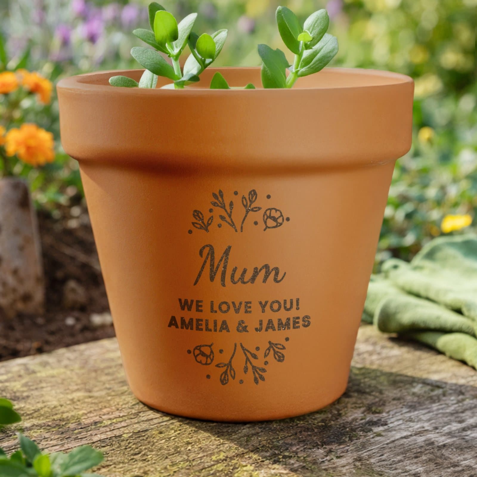 Personalised floral terracotta plant pot engraved with three lines of text