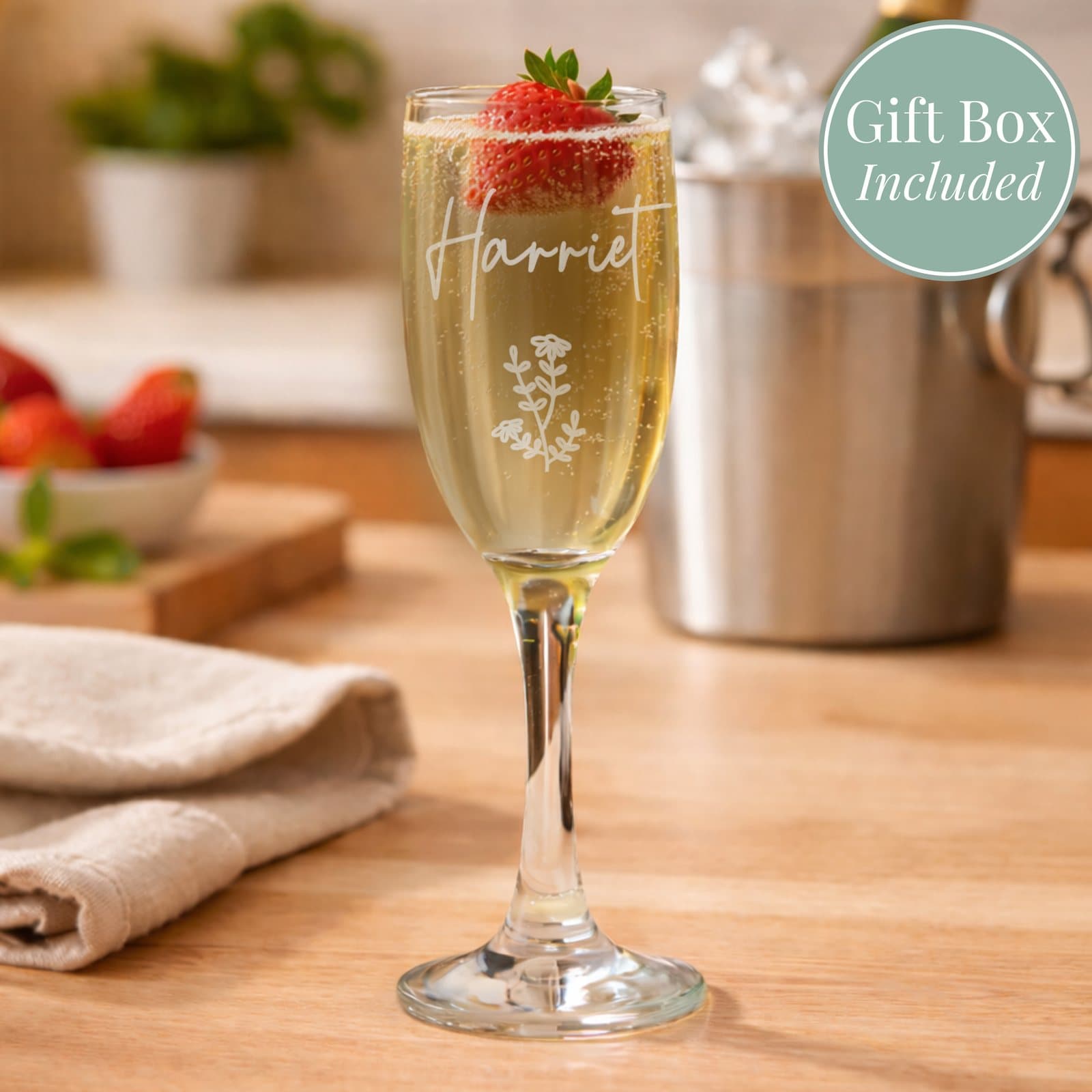 Glass champagne flute with a delicate floral design and a personalised name