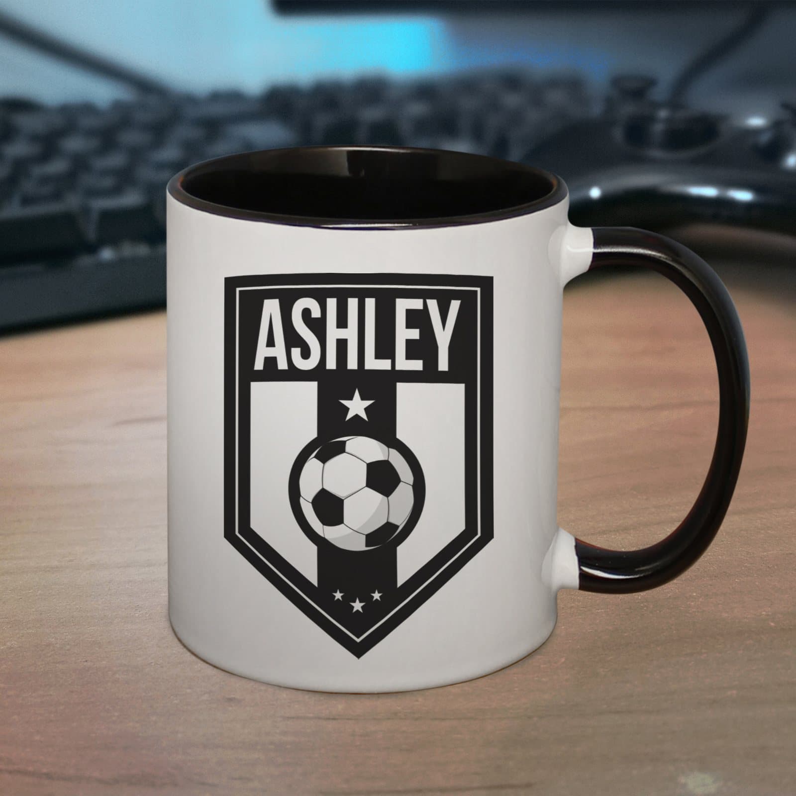 Black handled ceramic mug with a football themed badge for a name