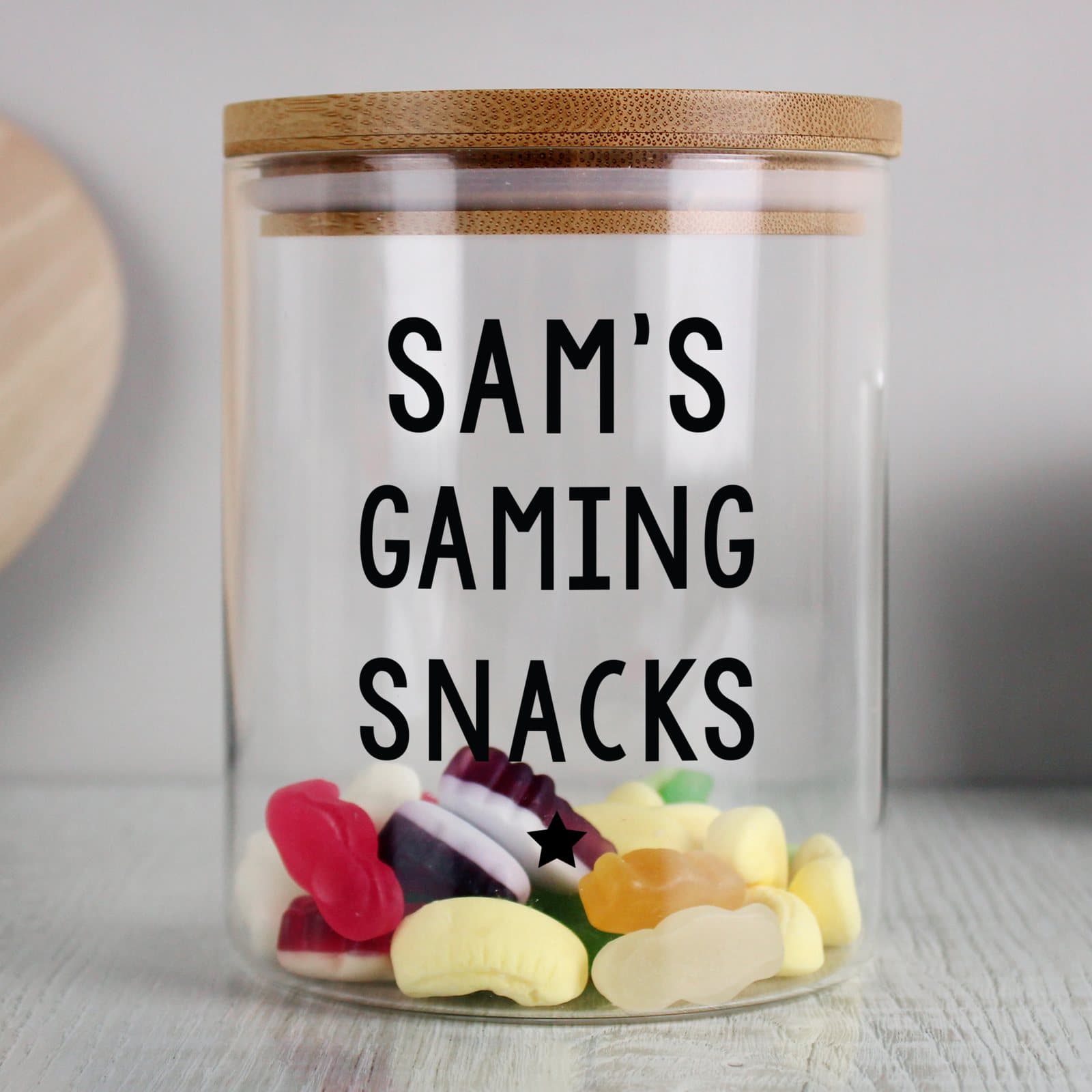 Glass jar with a bamboo lid and three lines of personalised text