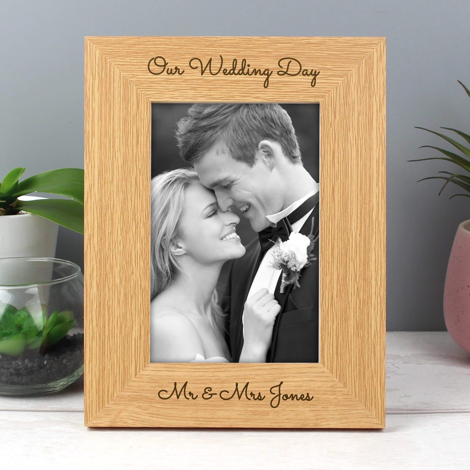 Oak veneer portrait photo frame with two lines of personalised text above the photo