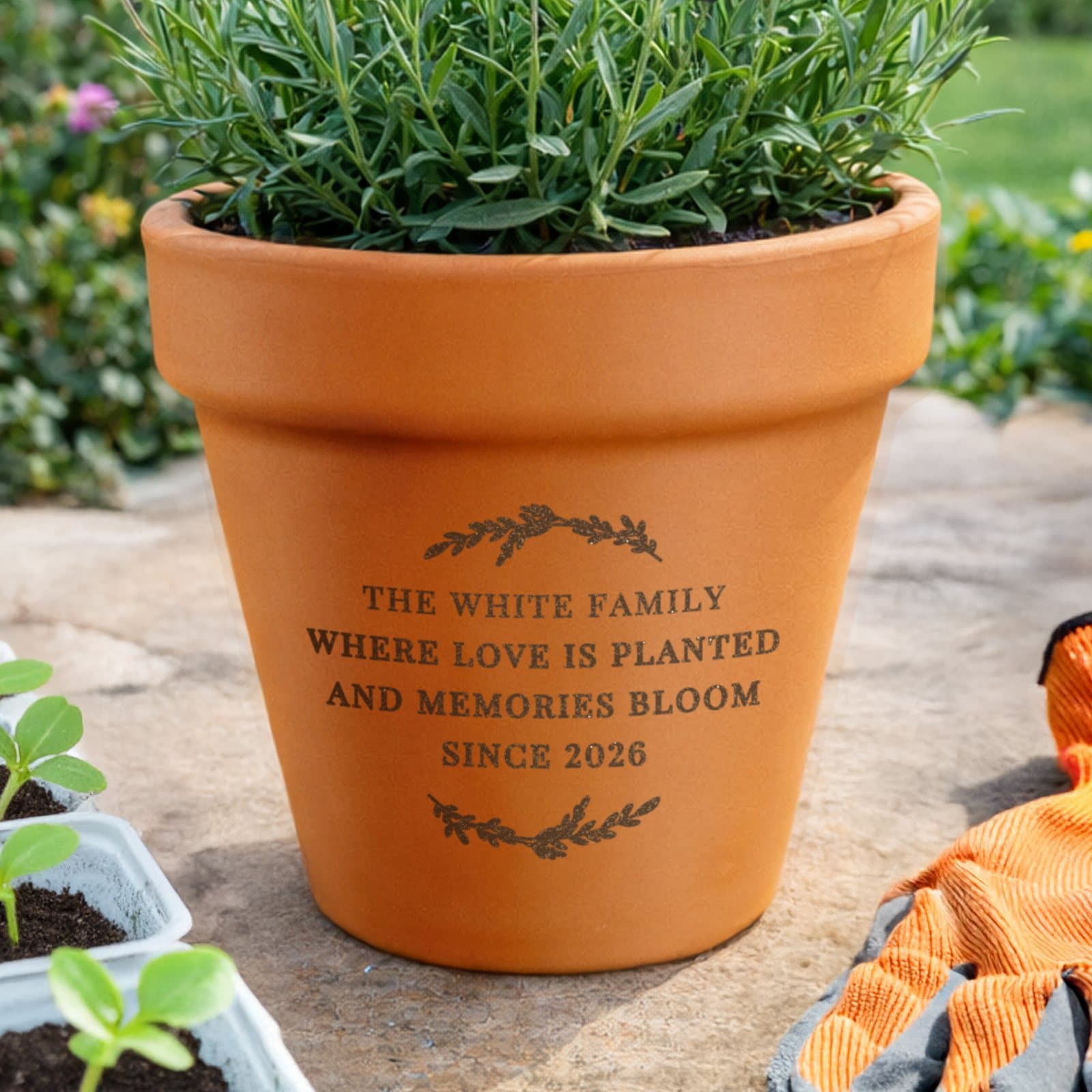 Floral terracotta plant pot engraved with four lines of text