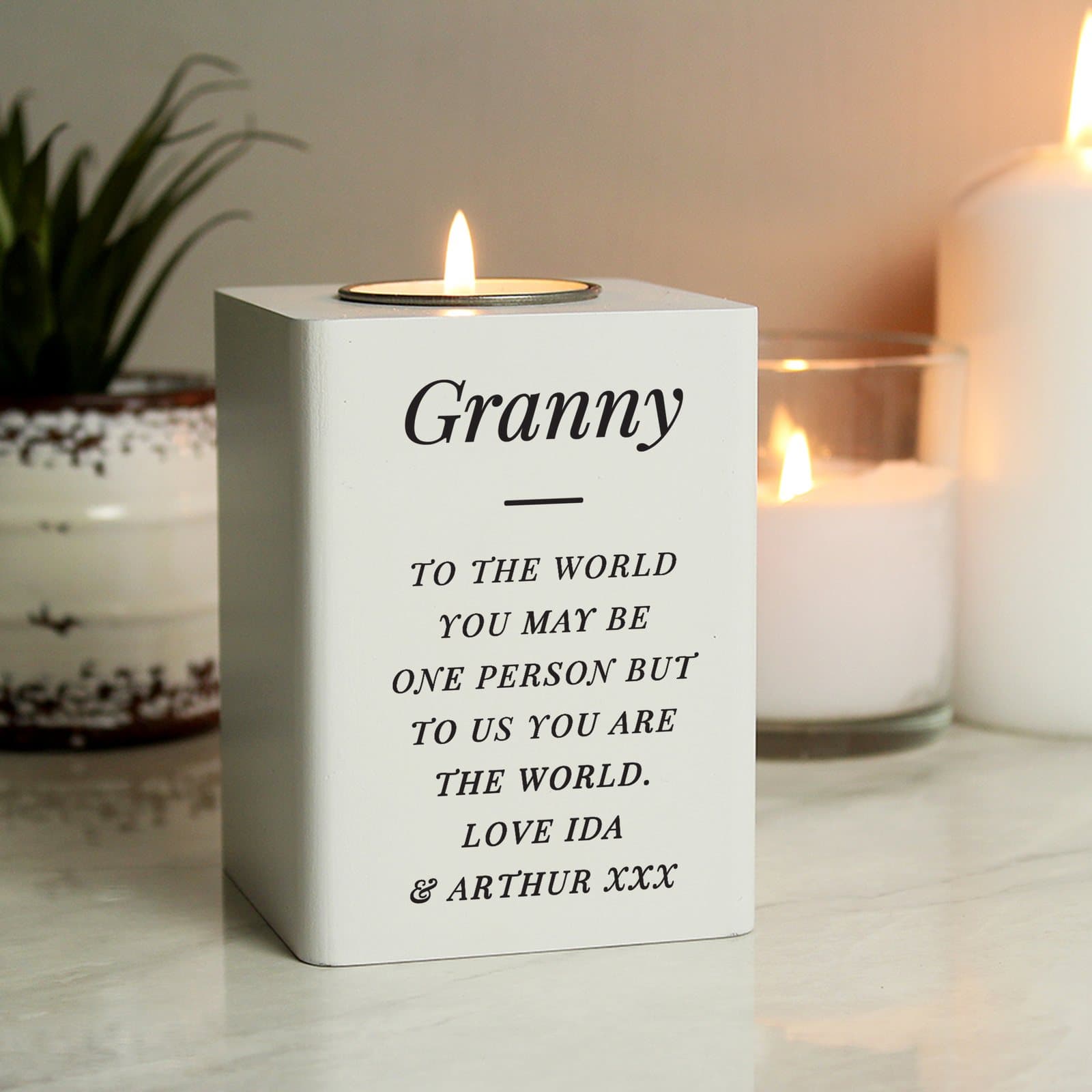 White wooden tea light holder personalised with lines of text