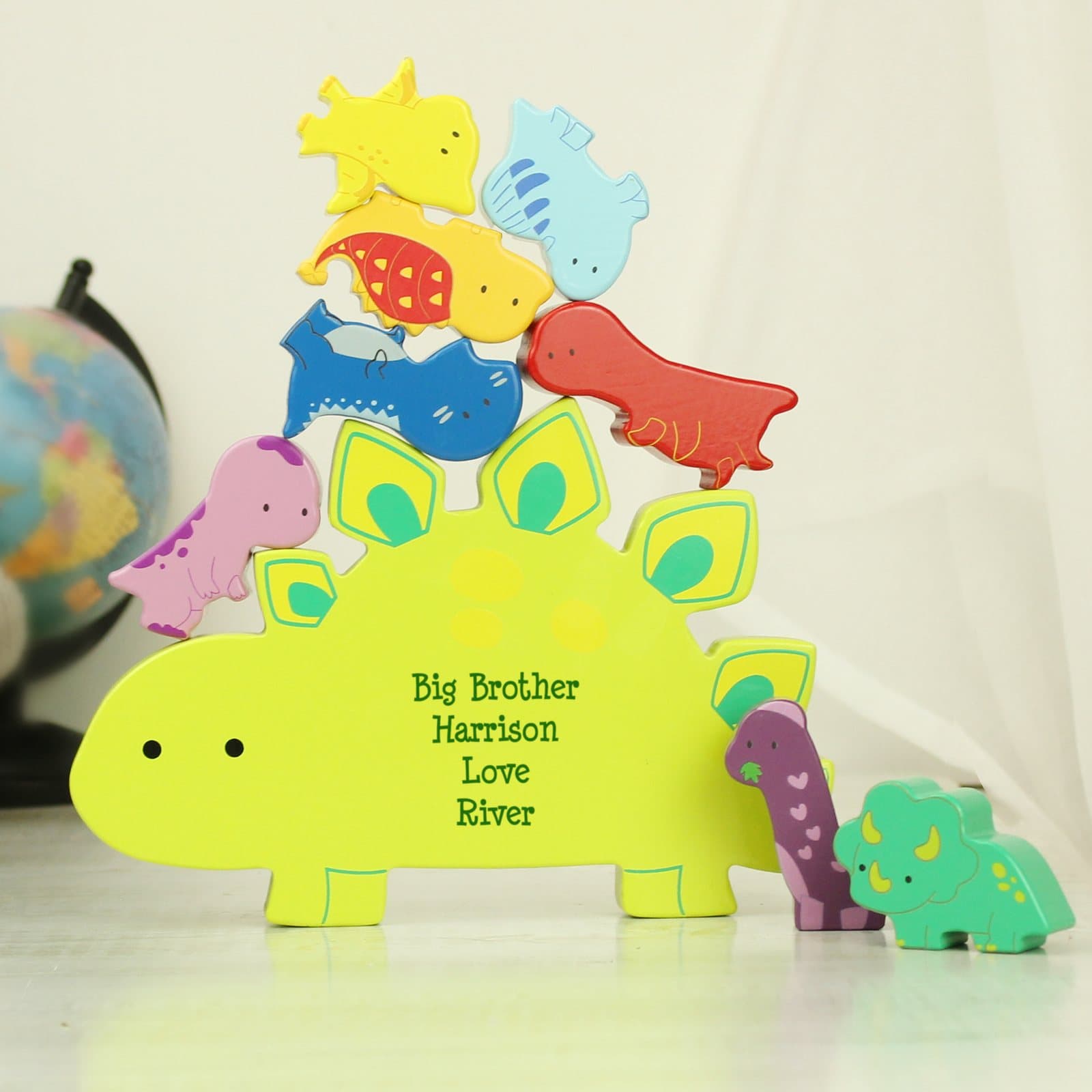 Wooden dinosaur stacker toy with colourful pieces and a personalised message