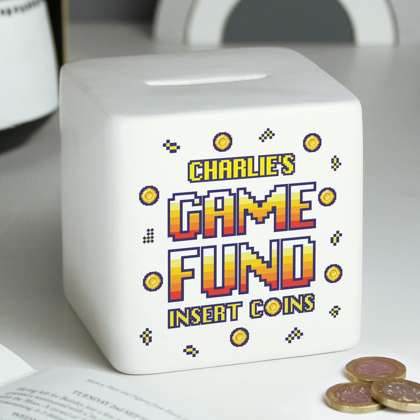 Square ceramic Gaming Fund money box with a name