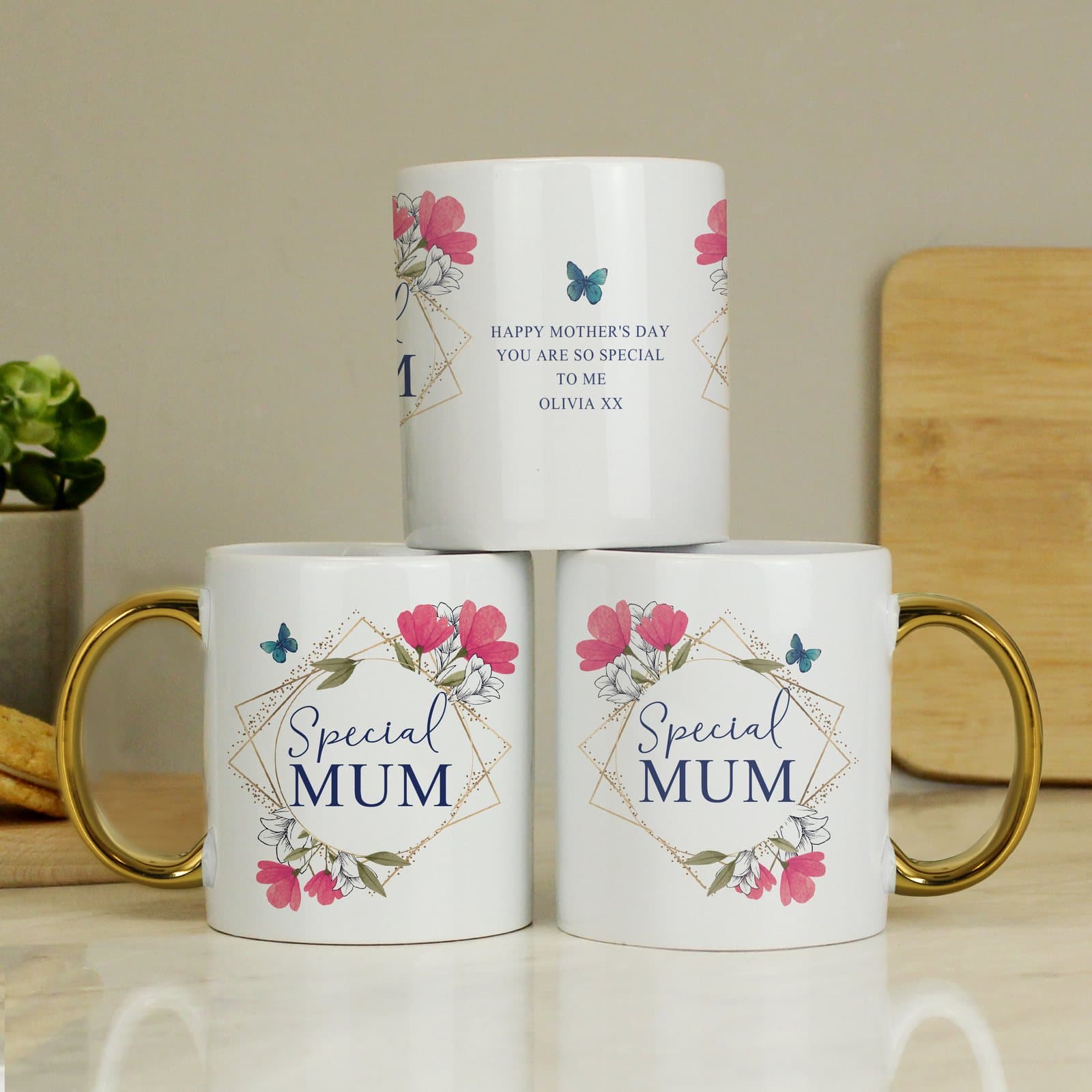 Ceramic floral mug with a gold handle and geometric design