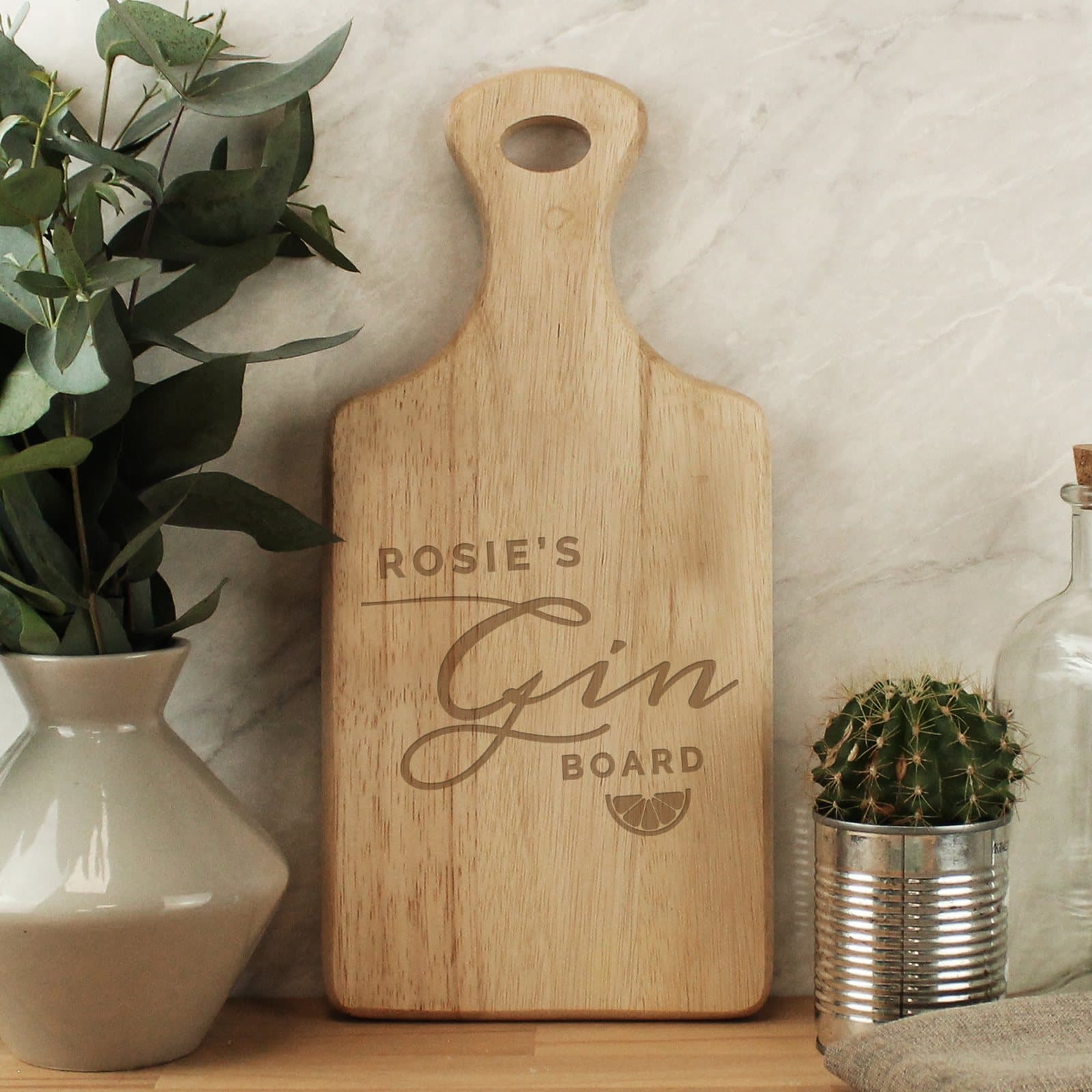 Hevea wood paddle board engraved with a line of text and the words Gin Board