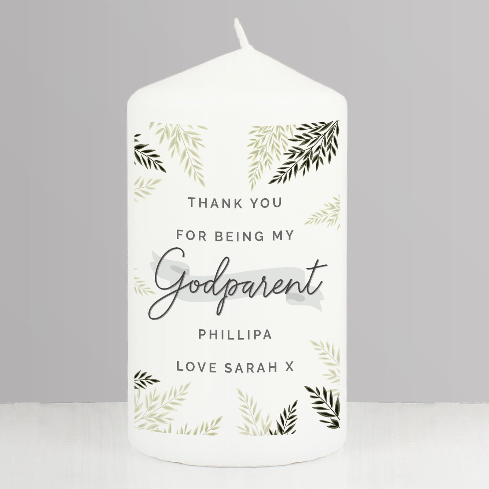Pillar candle with a leaves design and the word Godparent