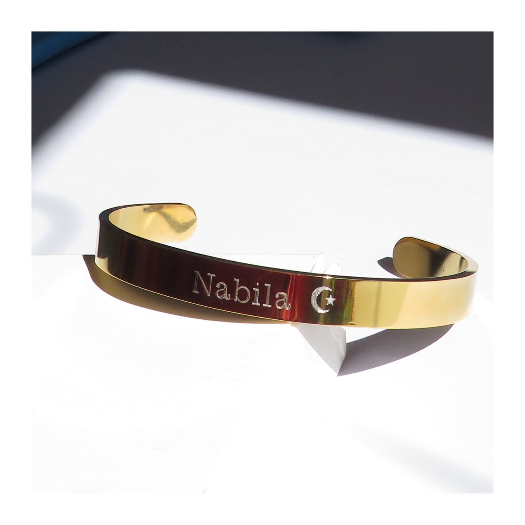 Gold coloured stainless steel bangle with a plain, simple design.