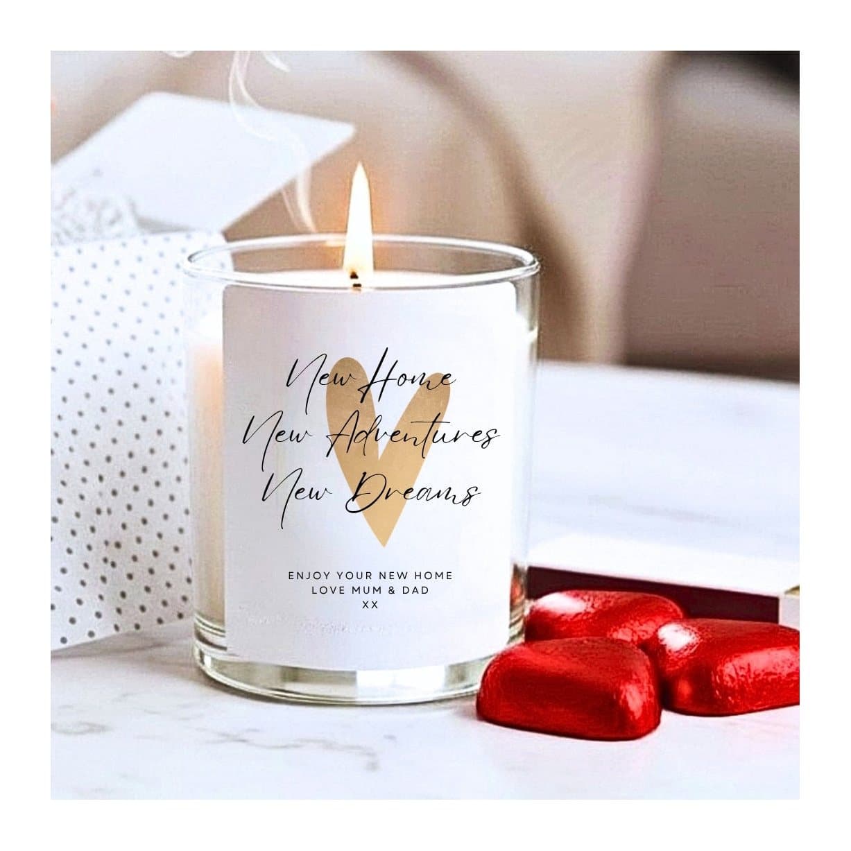 Gold heart new home candle with black lettering and a message on the bottom