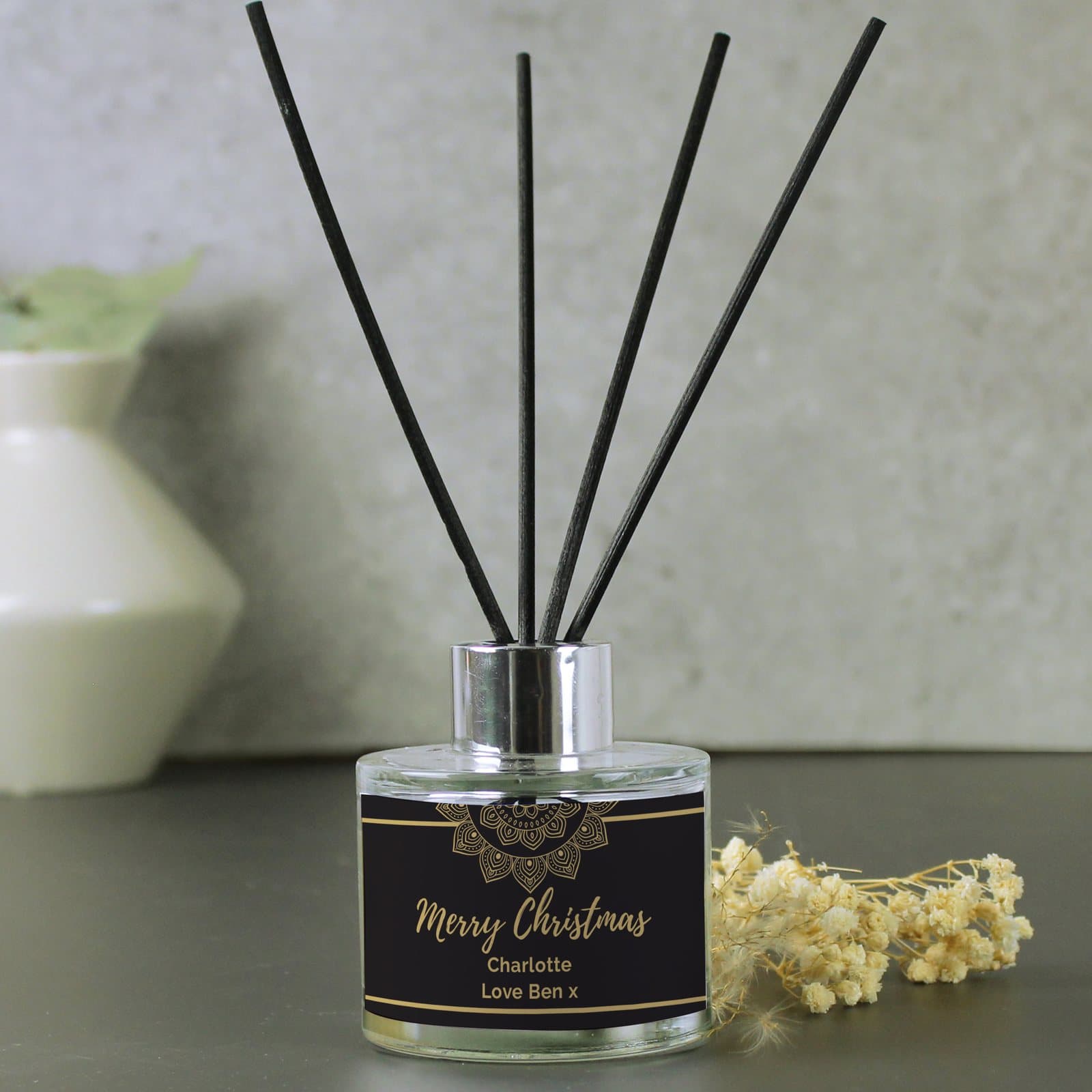 Personalised gold mandala reed diffuser in a glass bottle with reeds