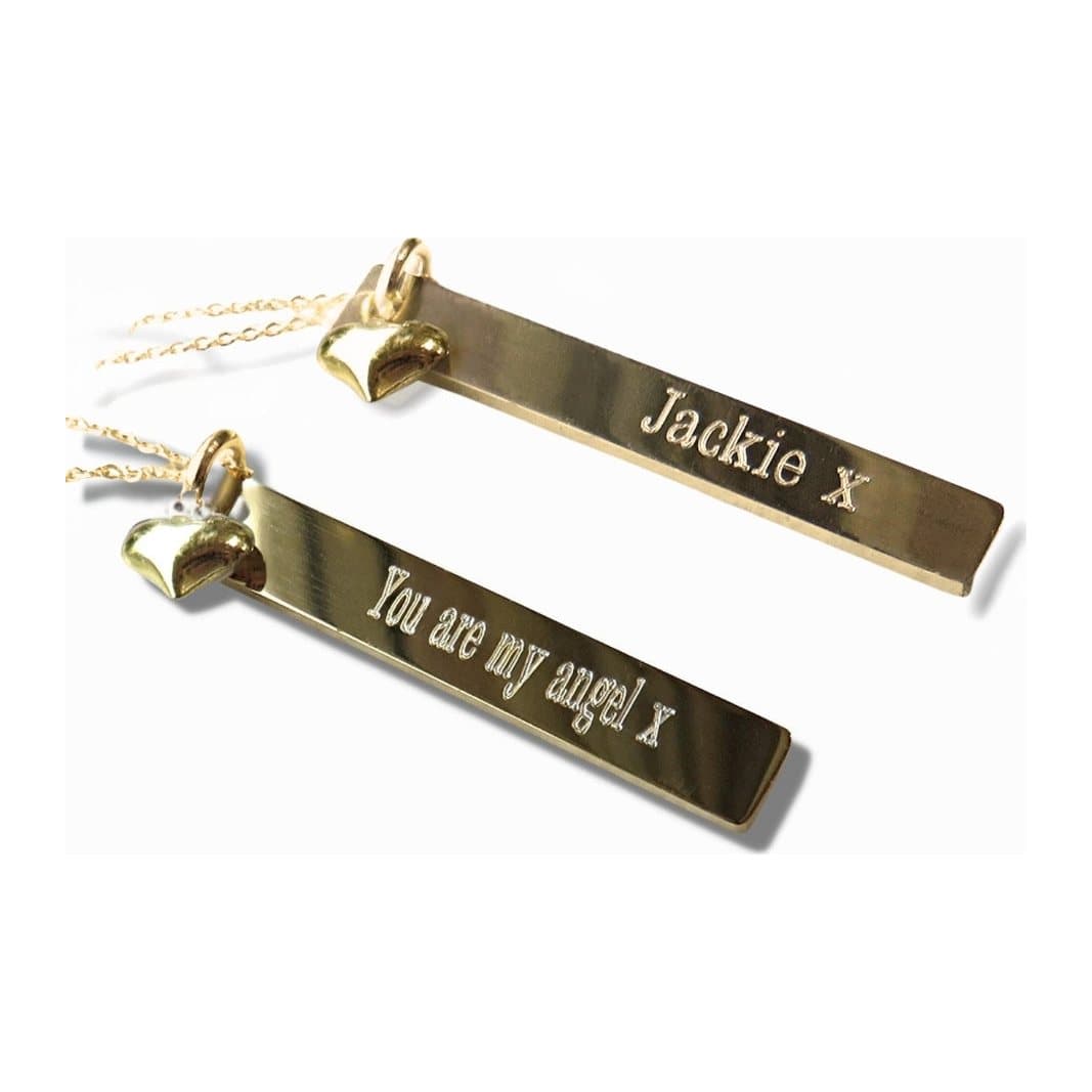 Gold plated necklace with a thin gold bar and a mini heart charm
