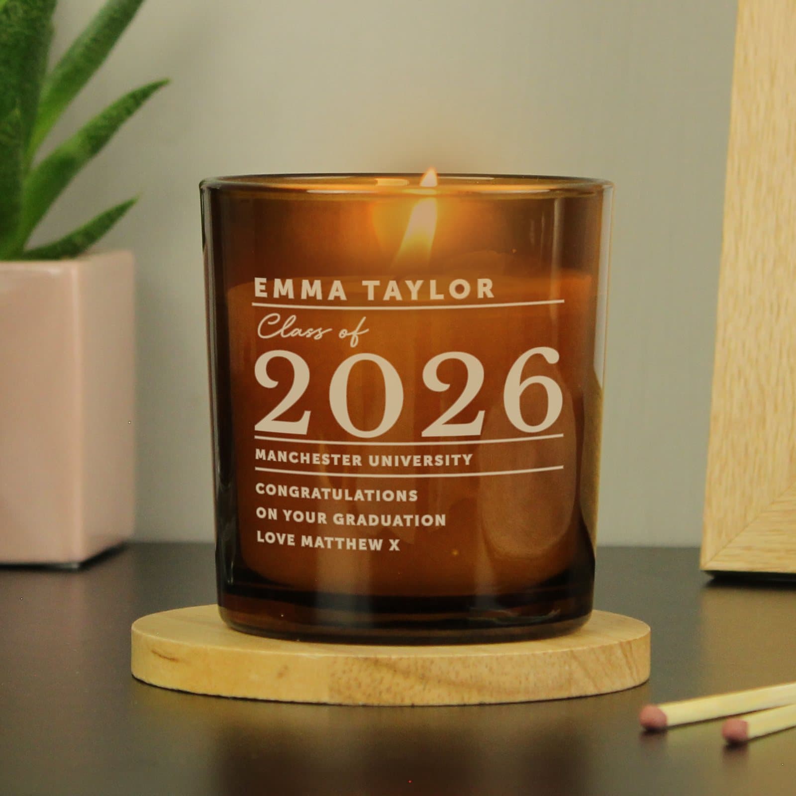 Amber glass candle jar engraved with Class of and graduate details
