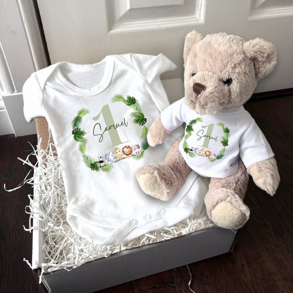 A teddy bear and a baby vest with the Green Boys 1st design