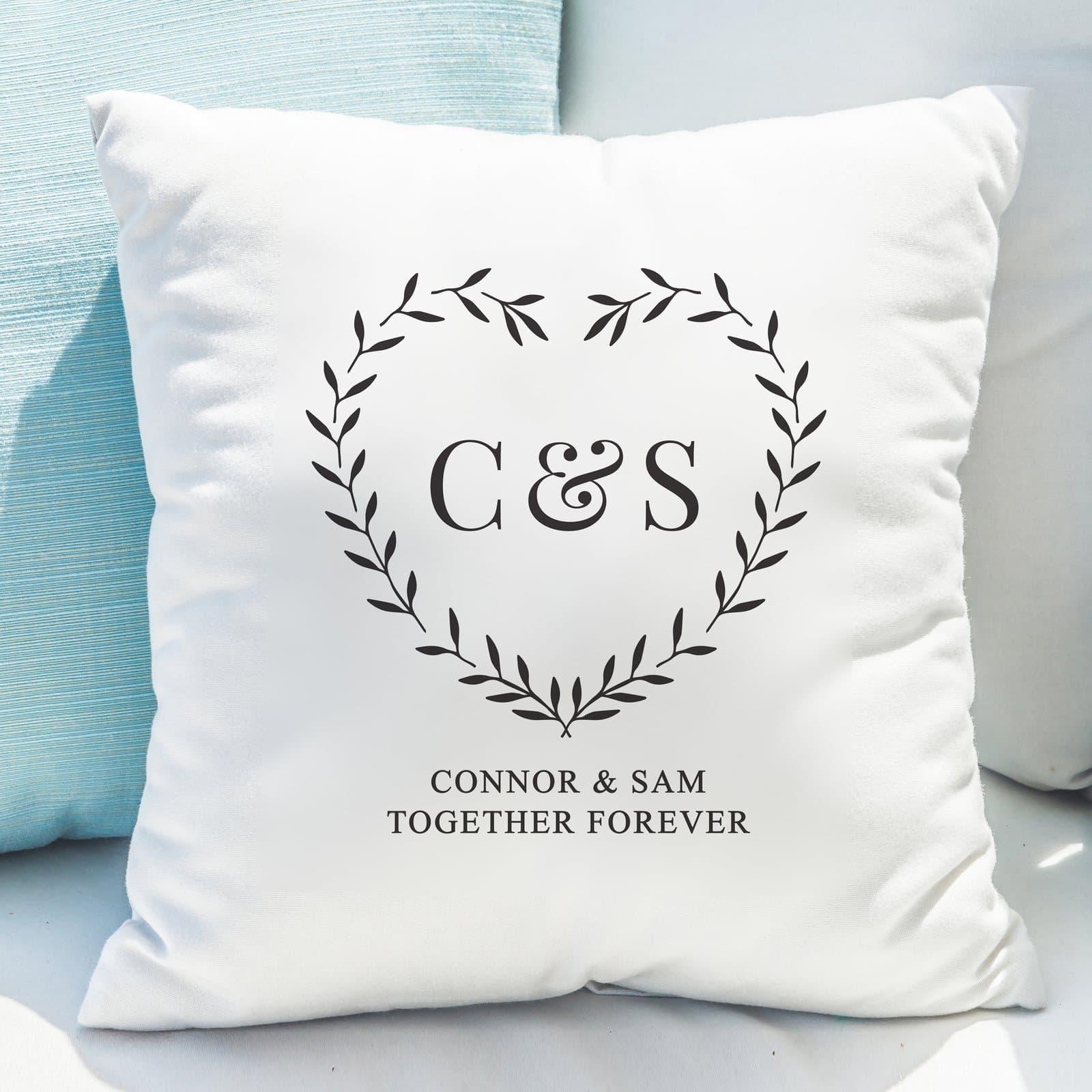 Grey heart cushion with two initials and a message