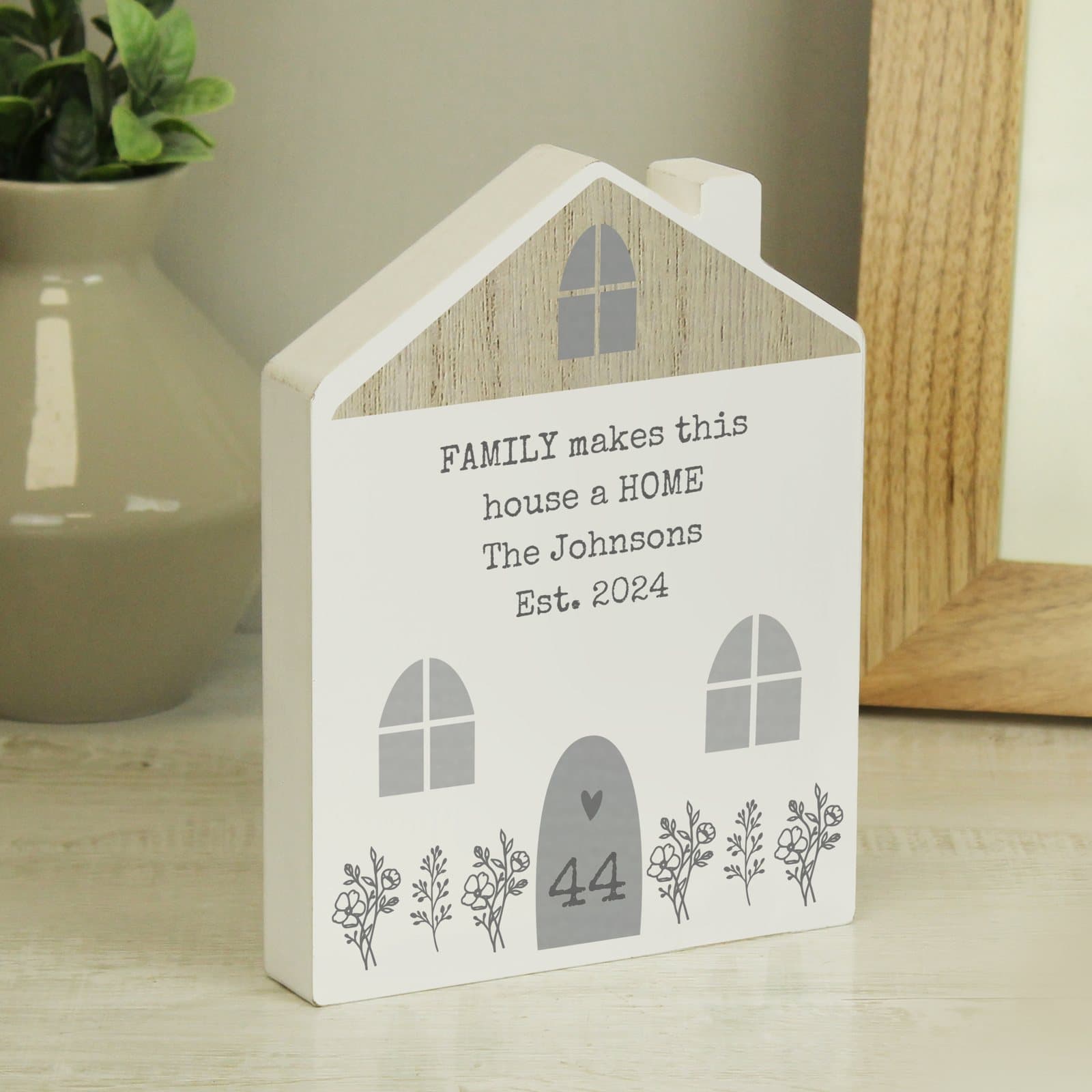 Grey wooden house ornament with a door