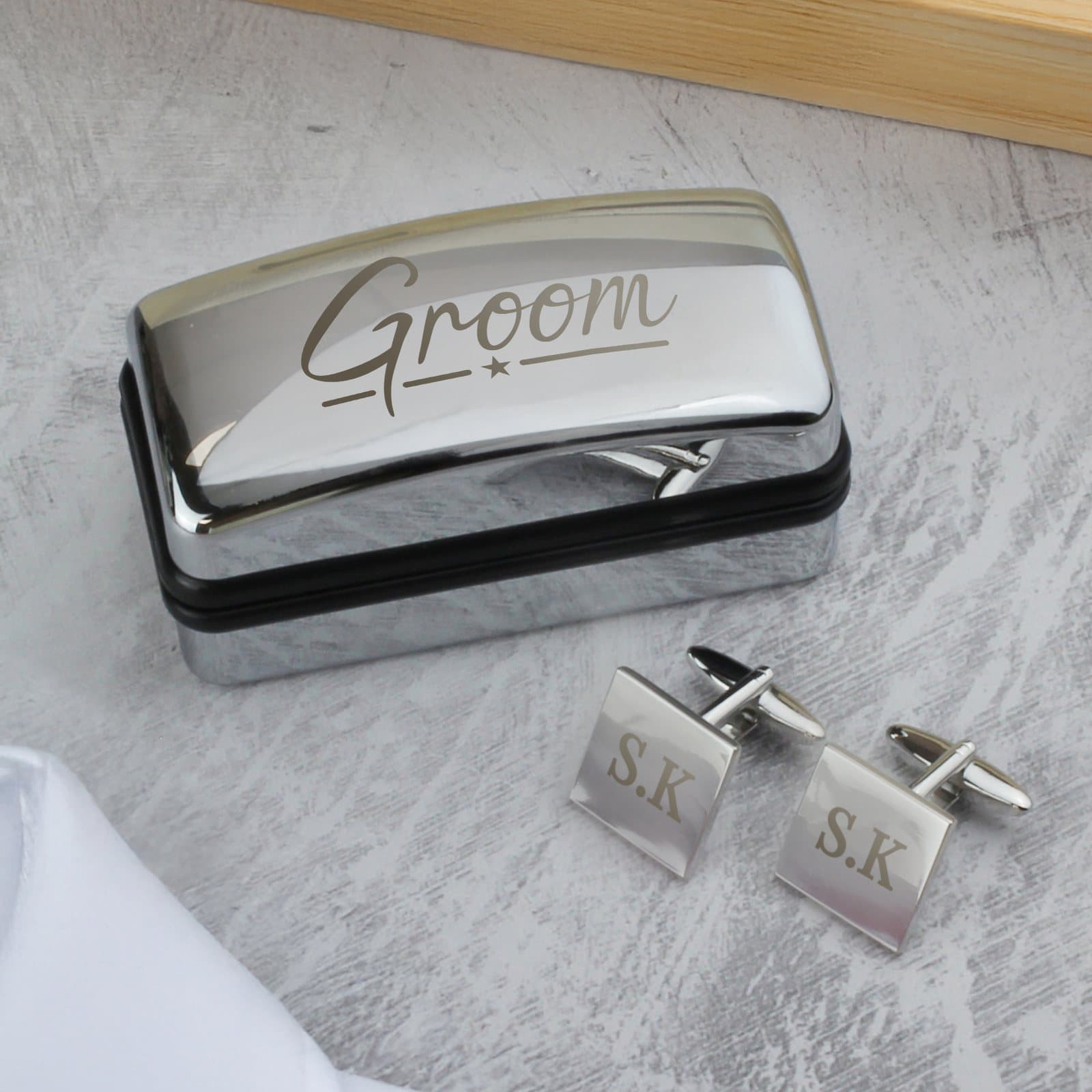 Square cufflinks in a chrome-effect box with Groom engraved on the lid
