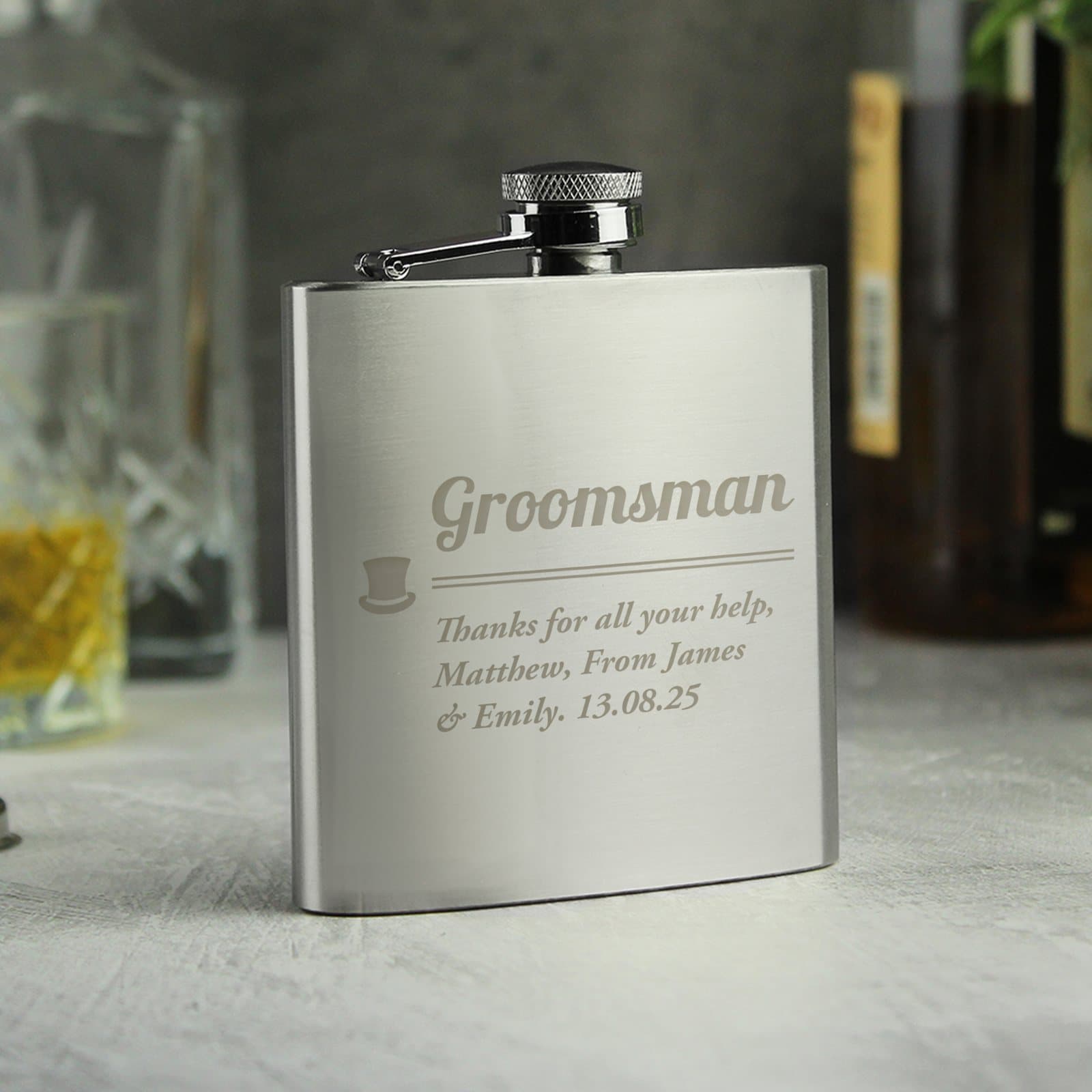 Stainless steel groomsman hip flask with personalised lines, shown with gift box