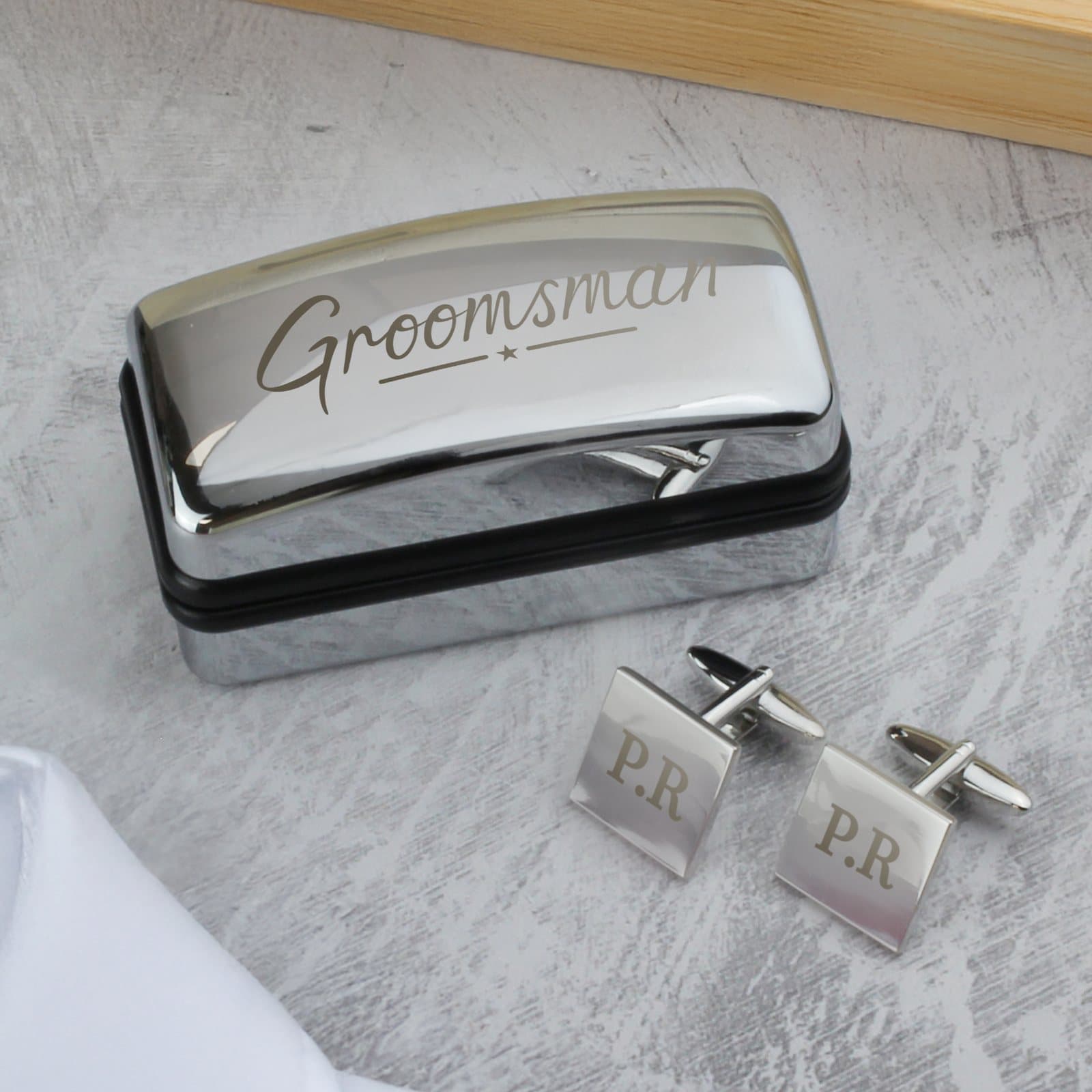Square cufflinks in a chrome-effect box with Groomsman engraved on the lid