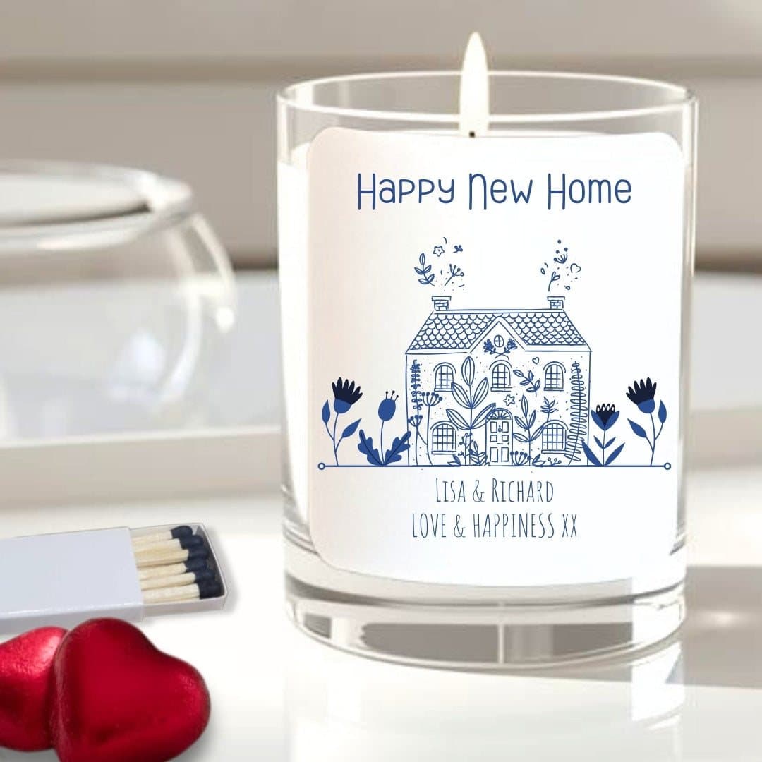 Happy new home candle with a little house design, red foil chocolate hearts and matches