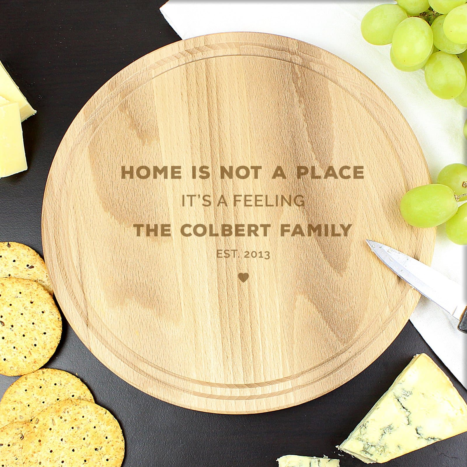 Round wooden chopping board with a heart motif and four lines of text