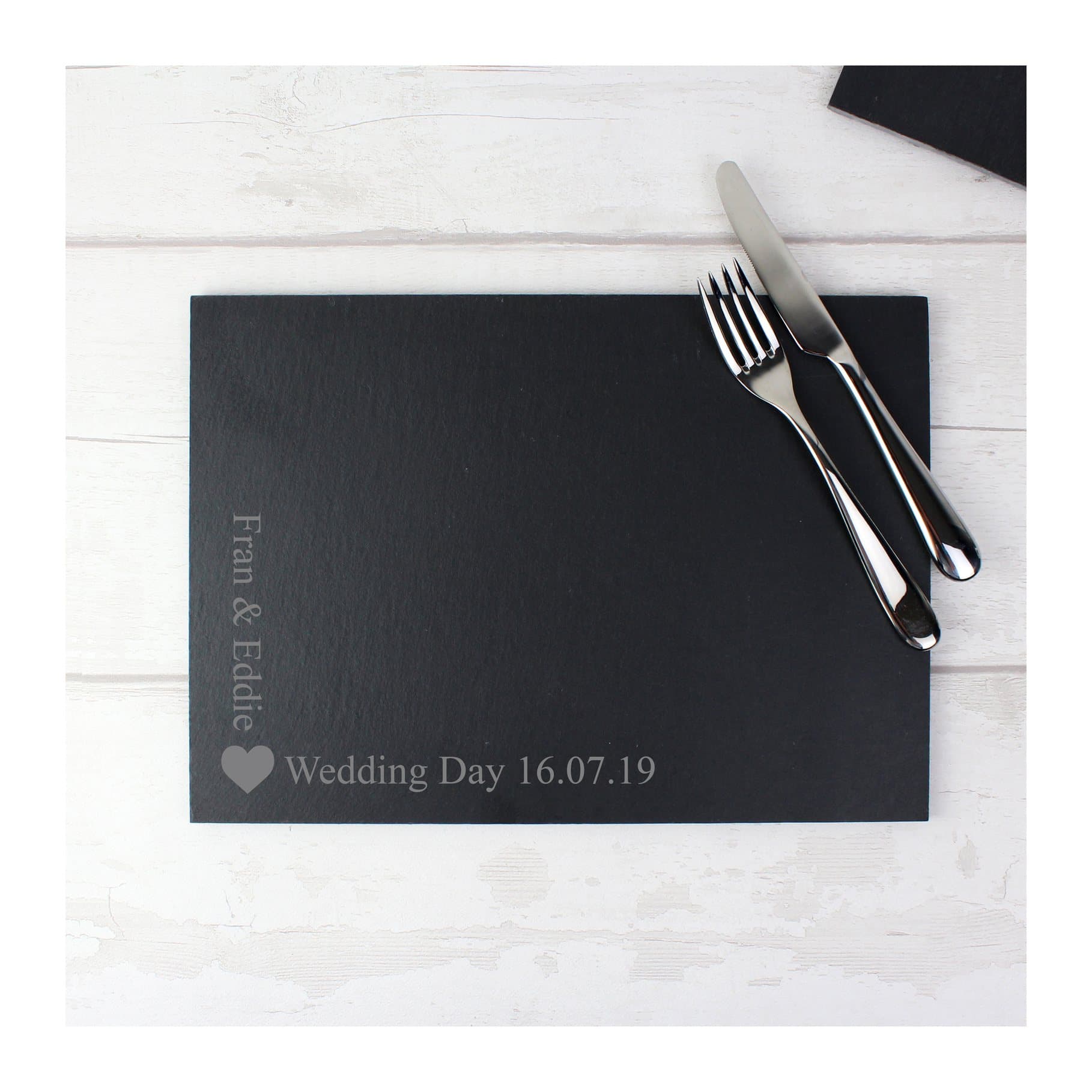 Slate placemat with a heart motif and personalised text in the corner