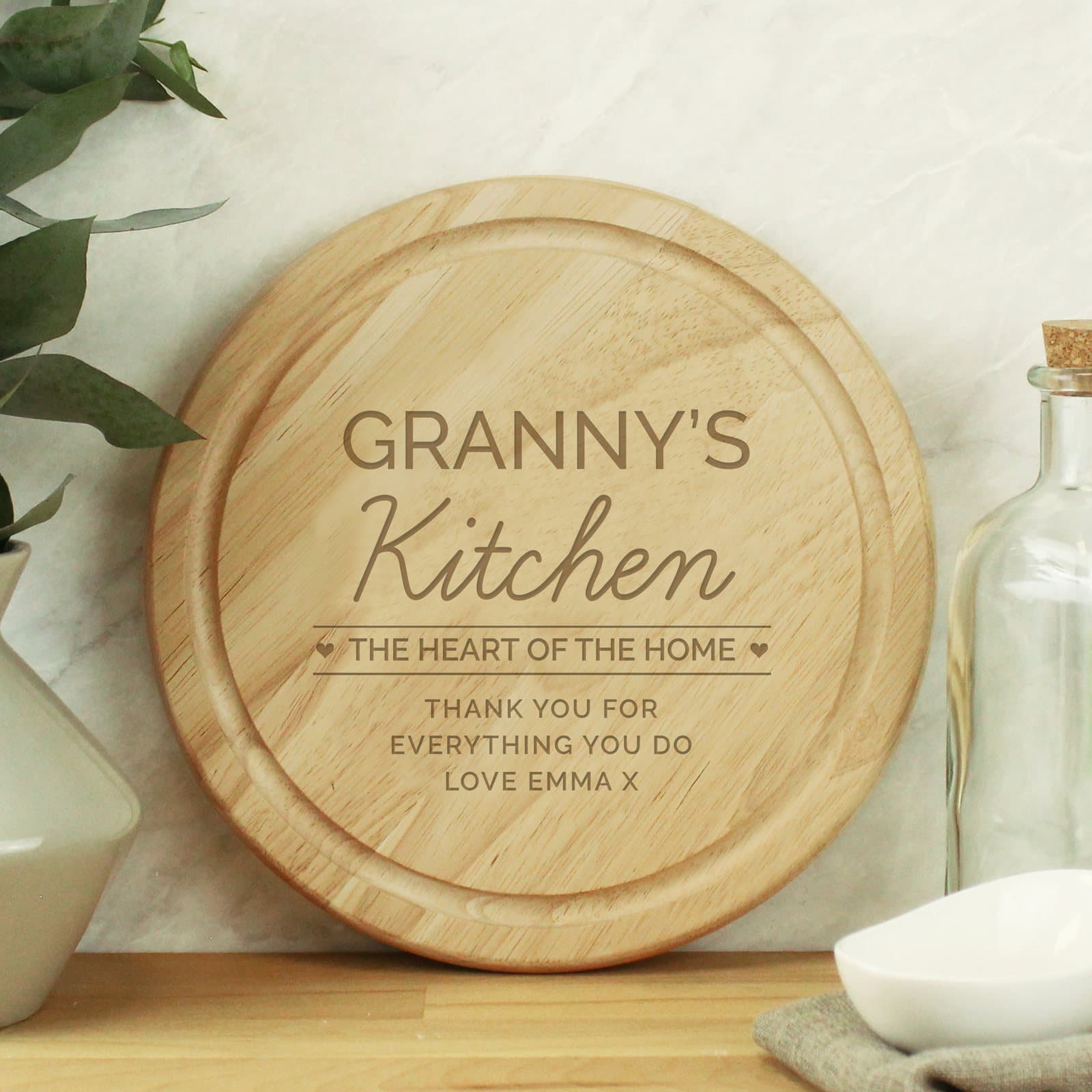 Round wooden chopping board with Kitchen and The heart of the home text