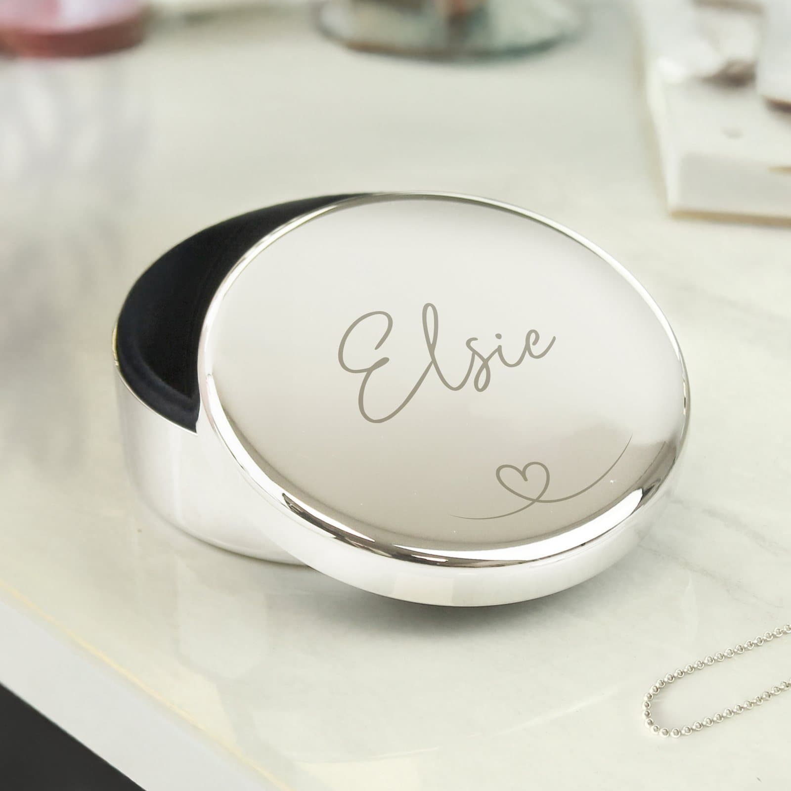 Round nickel plated trinket box with a heart motif and a name above it