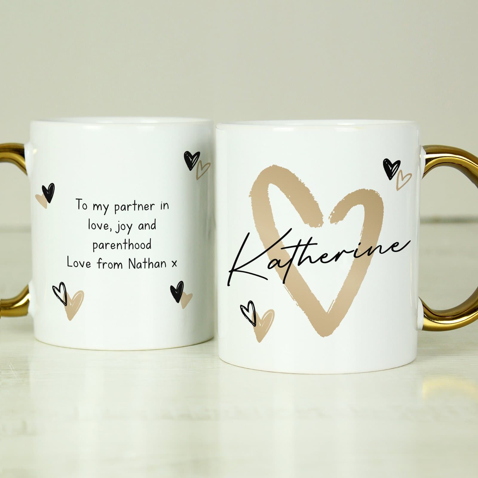 Personalised ceramic mug with a gold handle and a gold heart design