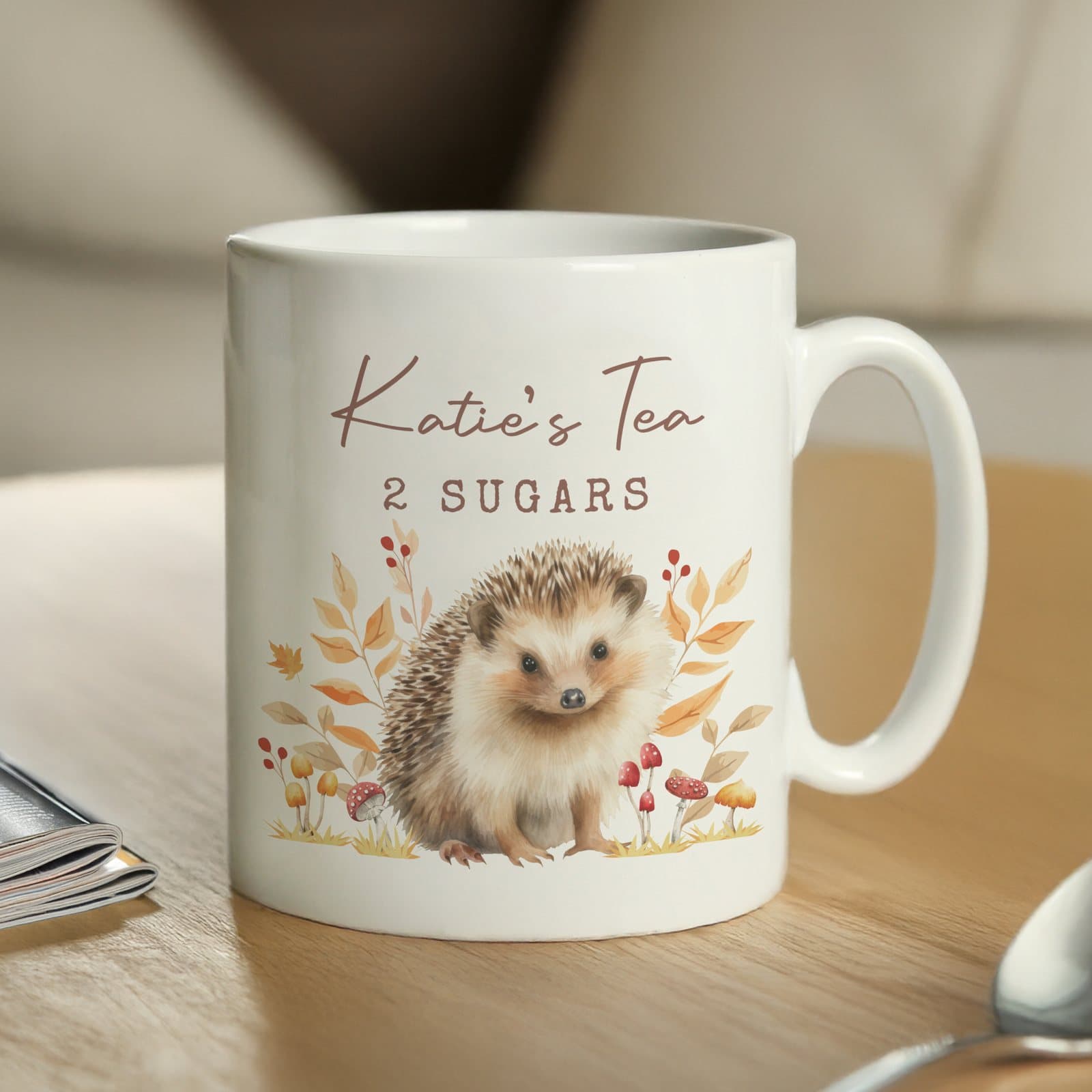 Personalised ceramic mug with a hedgehog design and two lines of text above it