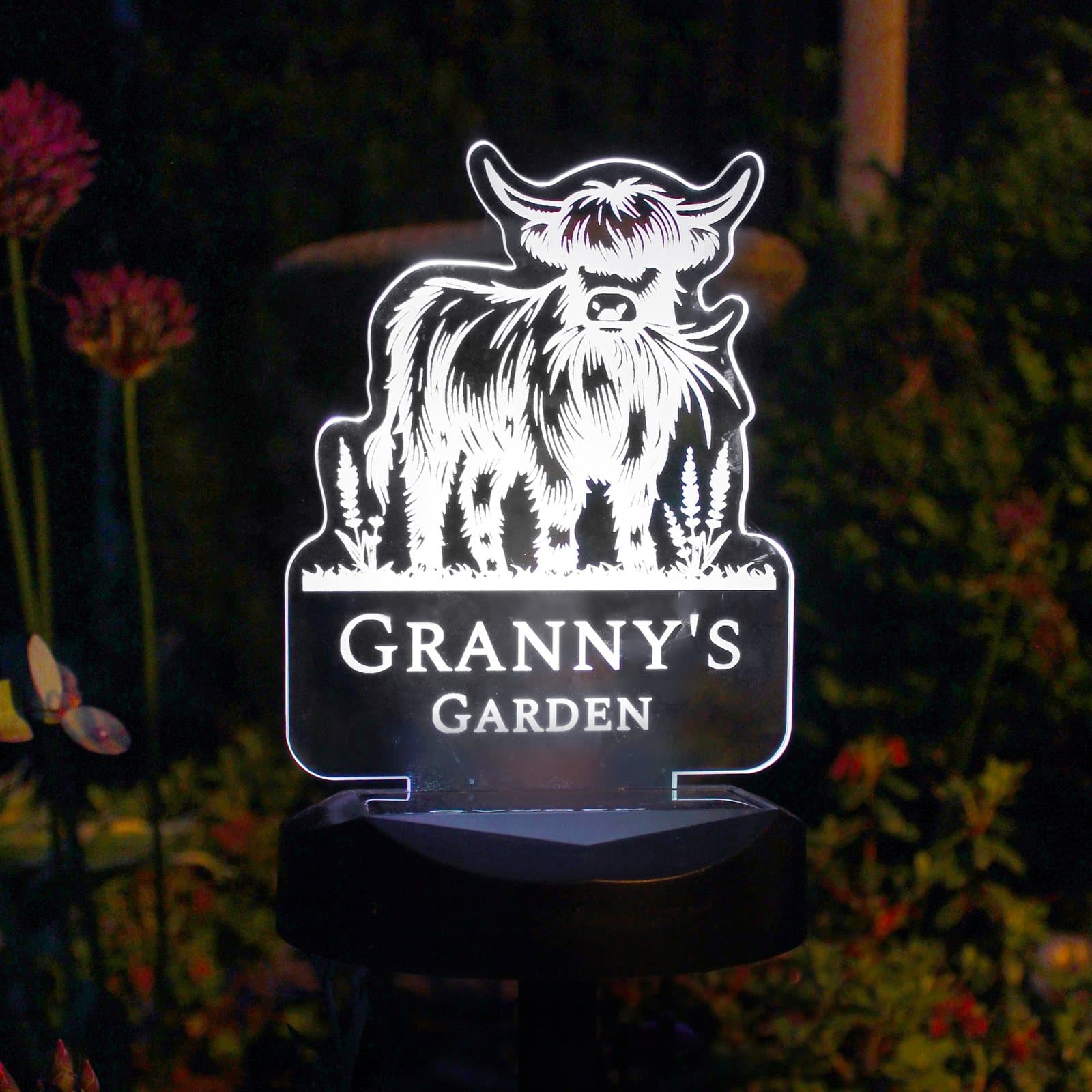 Highland cow solar garden light sign on a ground stick with solar panel base