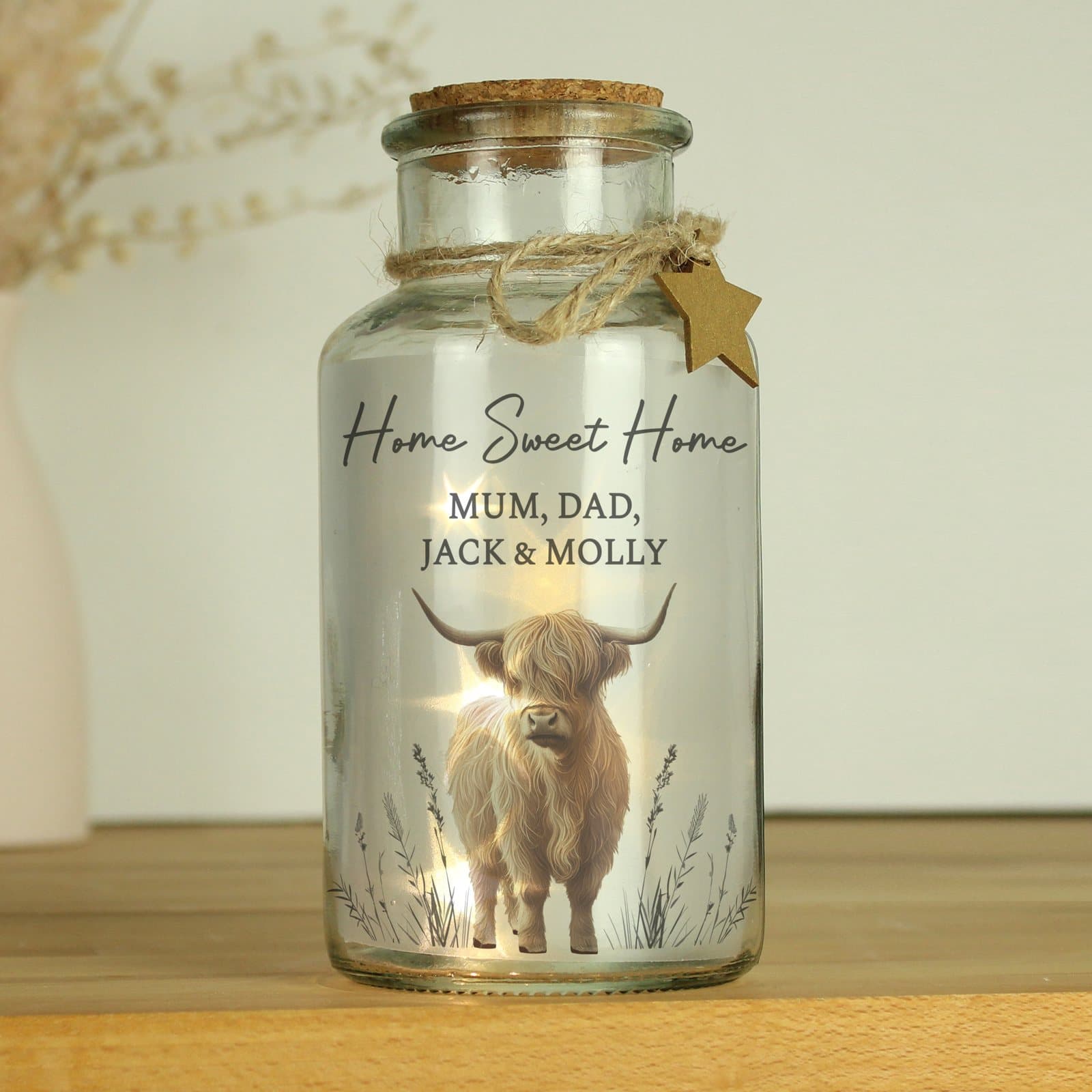 Glass jar with a Highland cow design and a personalised message