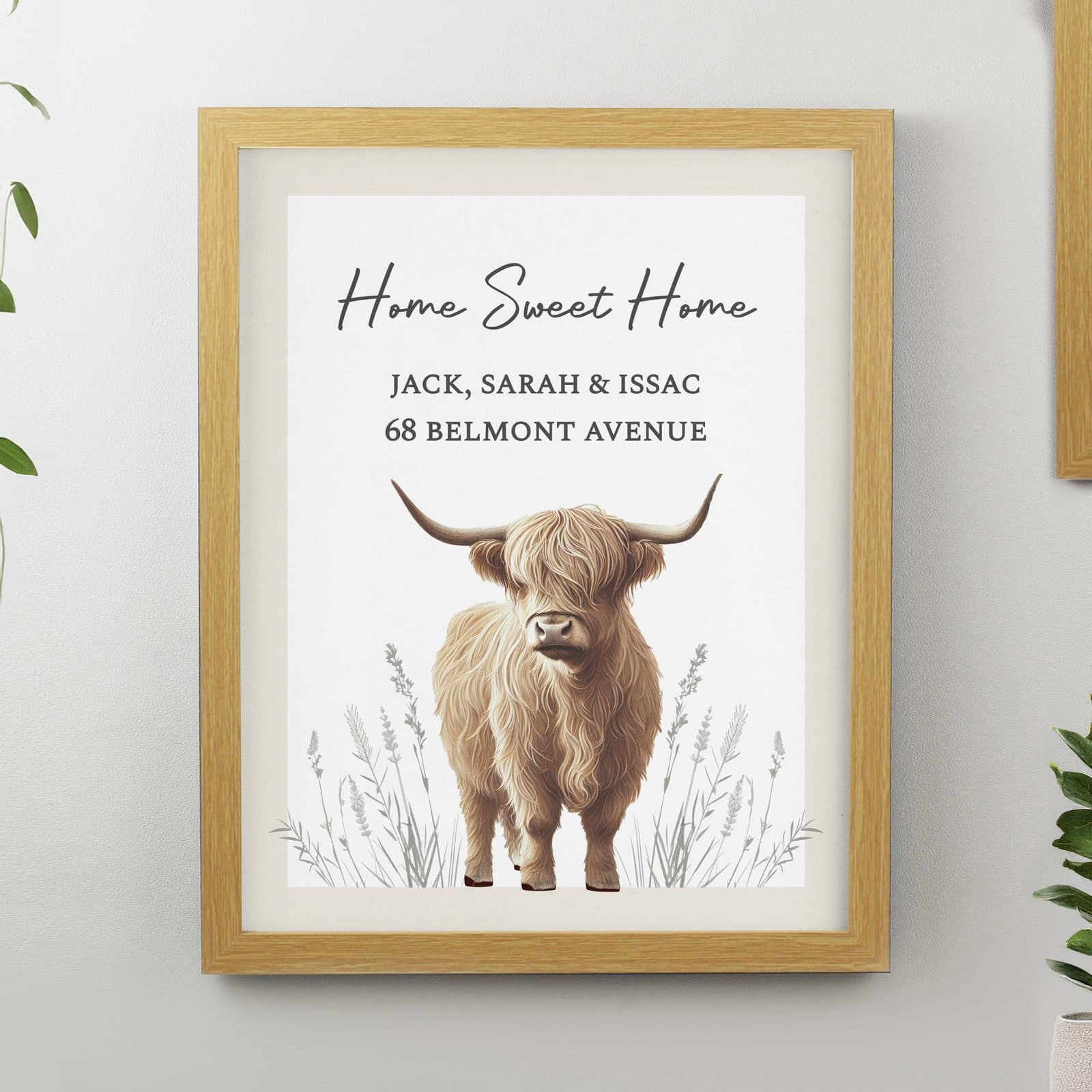 Highland cow illustration in a large oak frame with three lines of personalised text